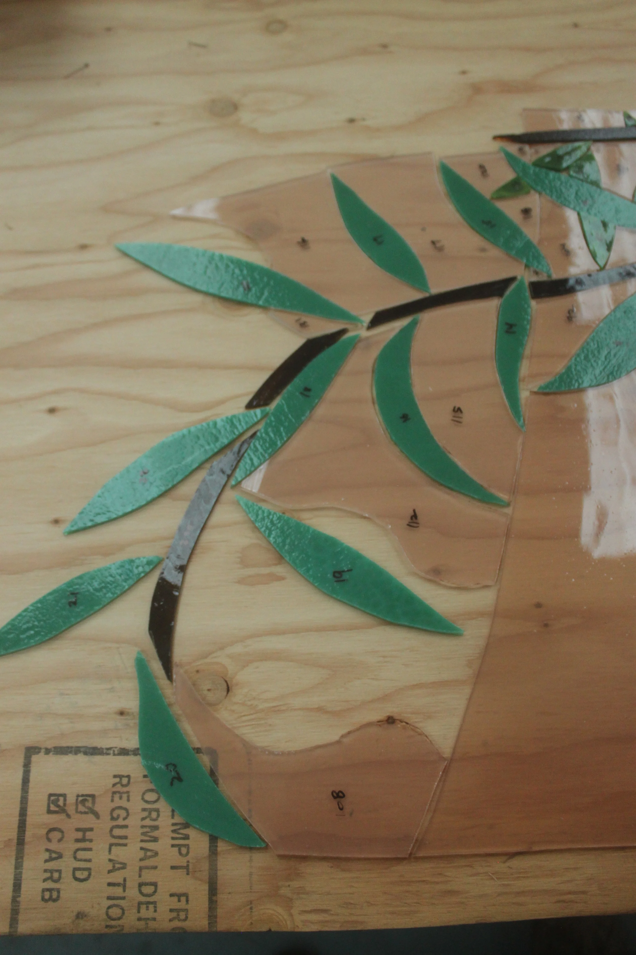 Some of the cut pieces laid out on a board, in preparation for assembly.