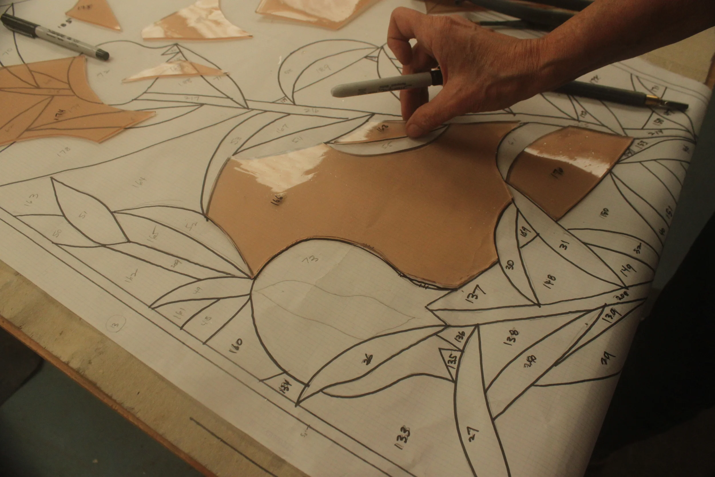  Michells checks a piece against the pattern for accuracy. 