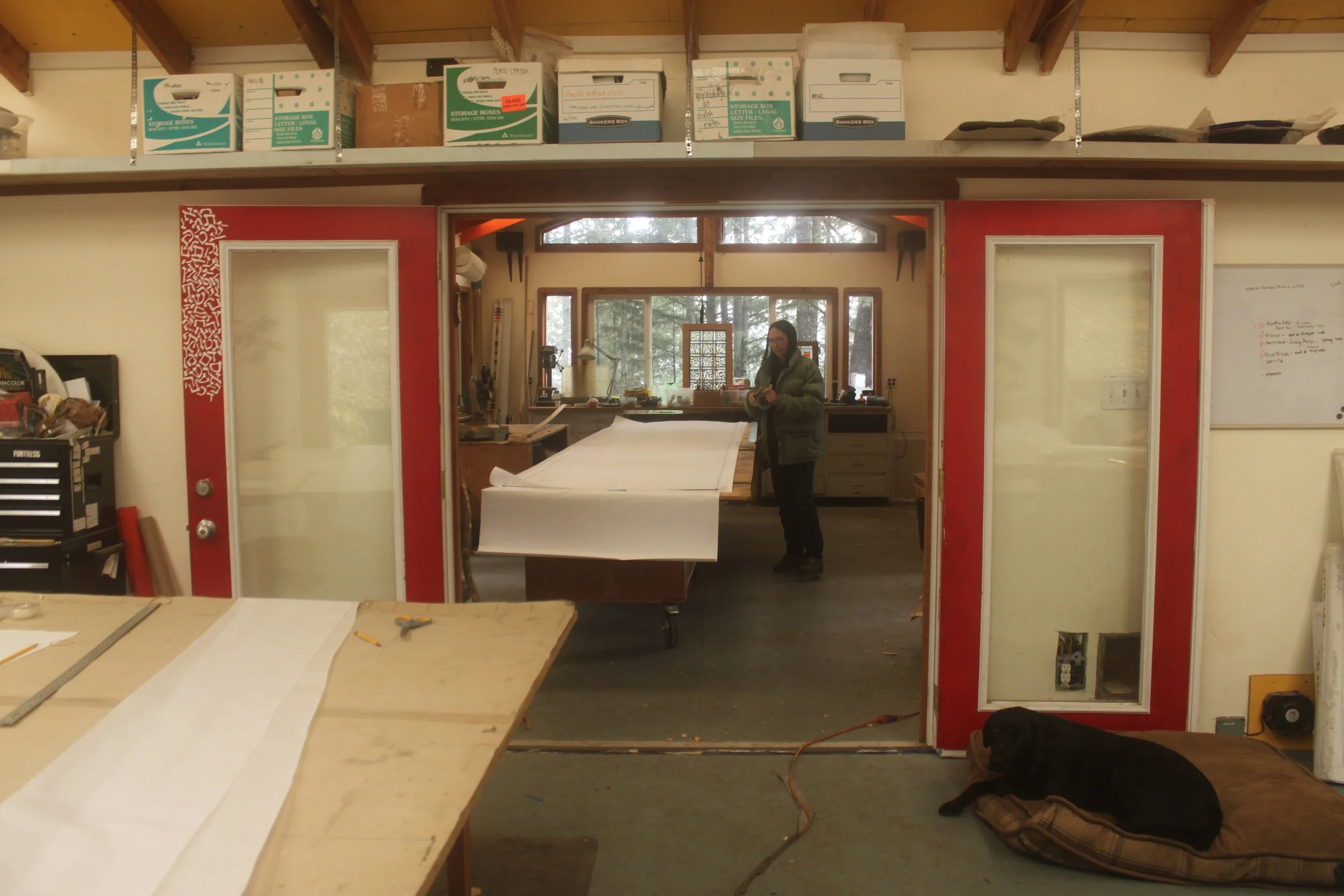 Michelle works on the long table in another work room.