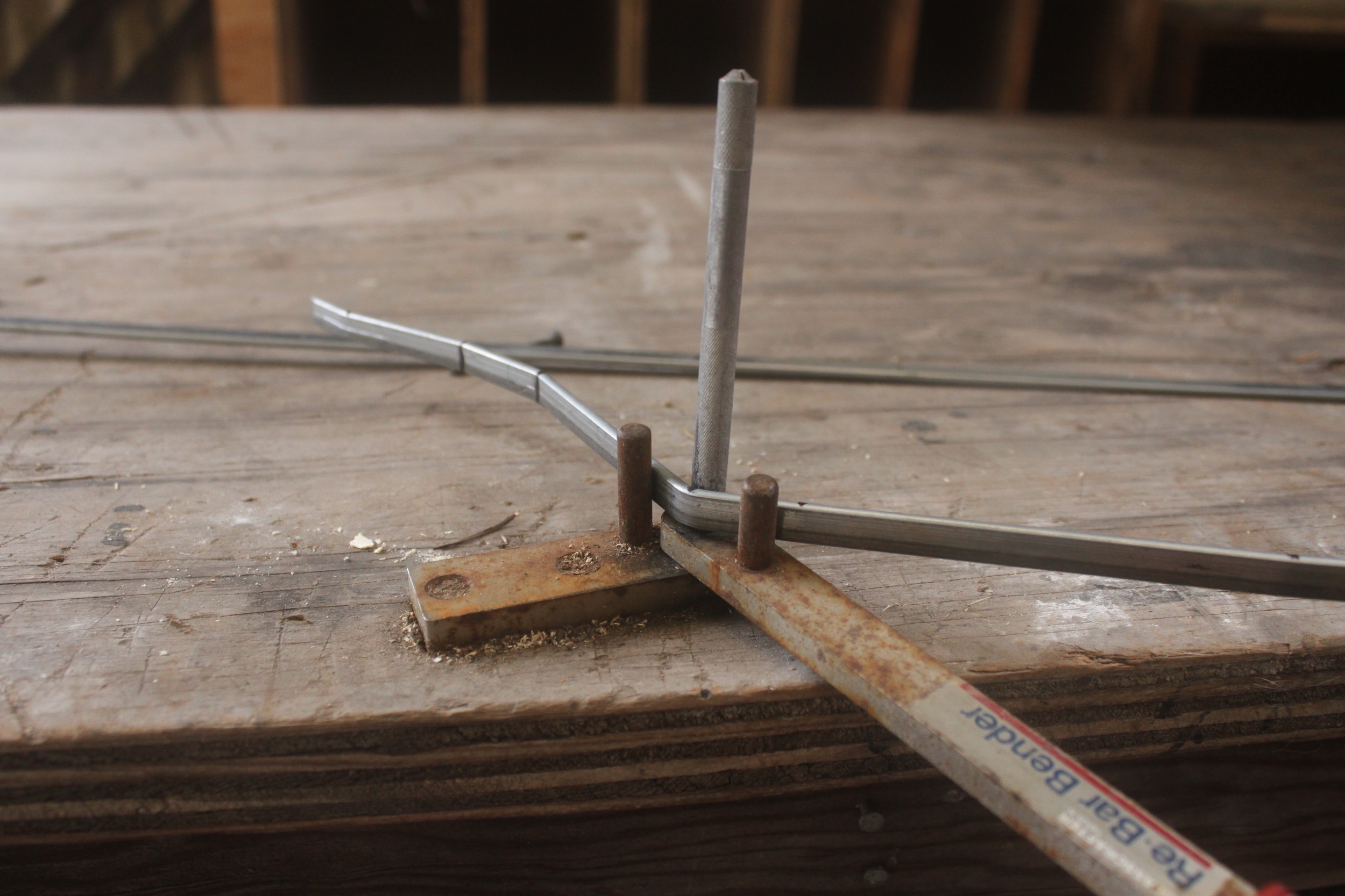 A bend is put in a steel bar using a hand operated bending jig.