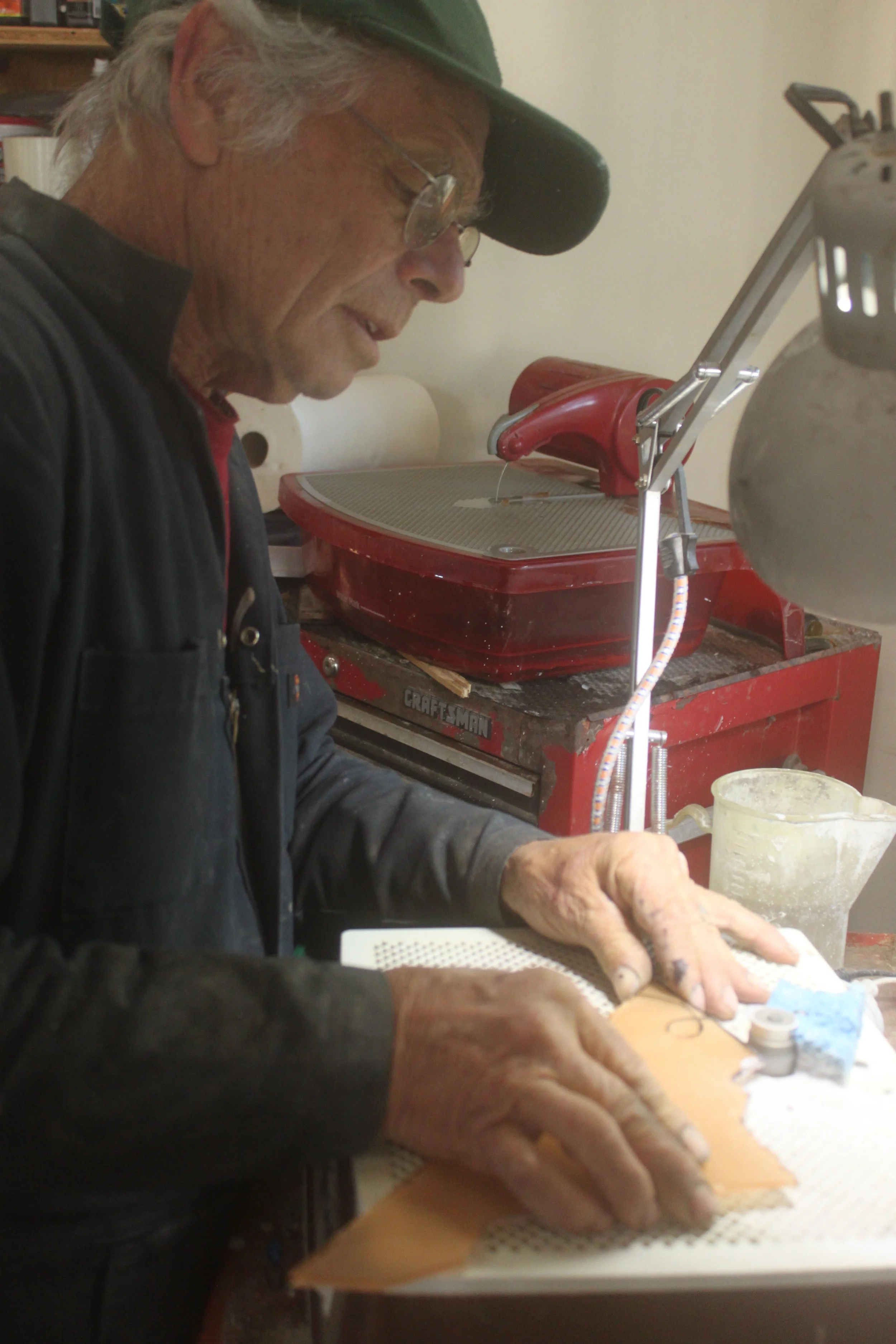 David works with the glass grinder to fine tune pieces during the assembly of panel #5.