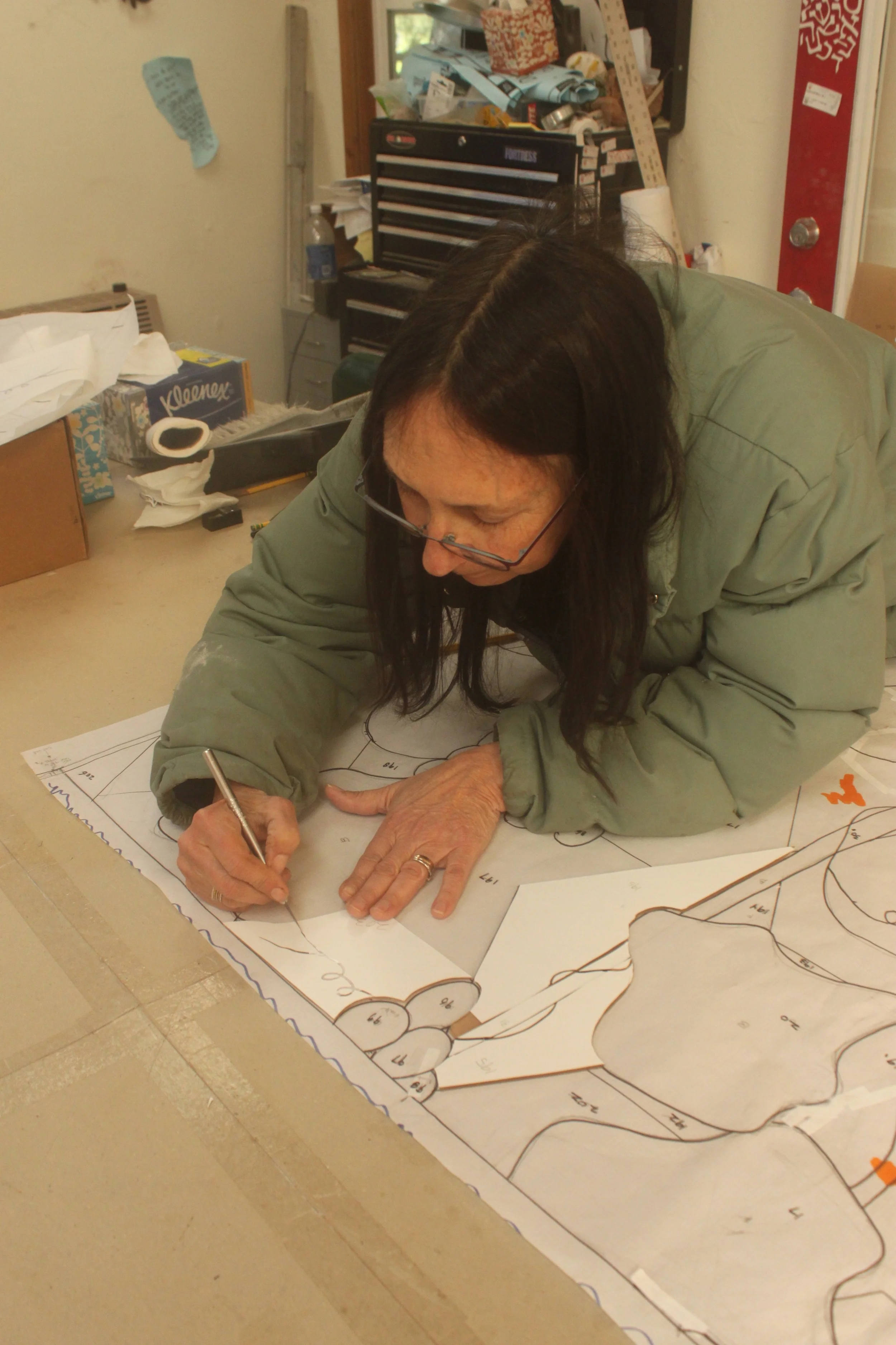 The tendril pieces are covered with resist and the tendrils are first drawn on and then cut out with the xacto knife.