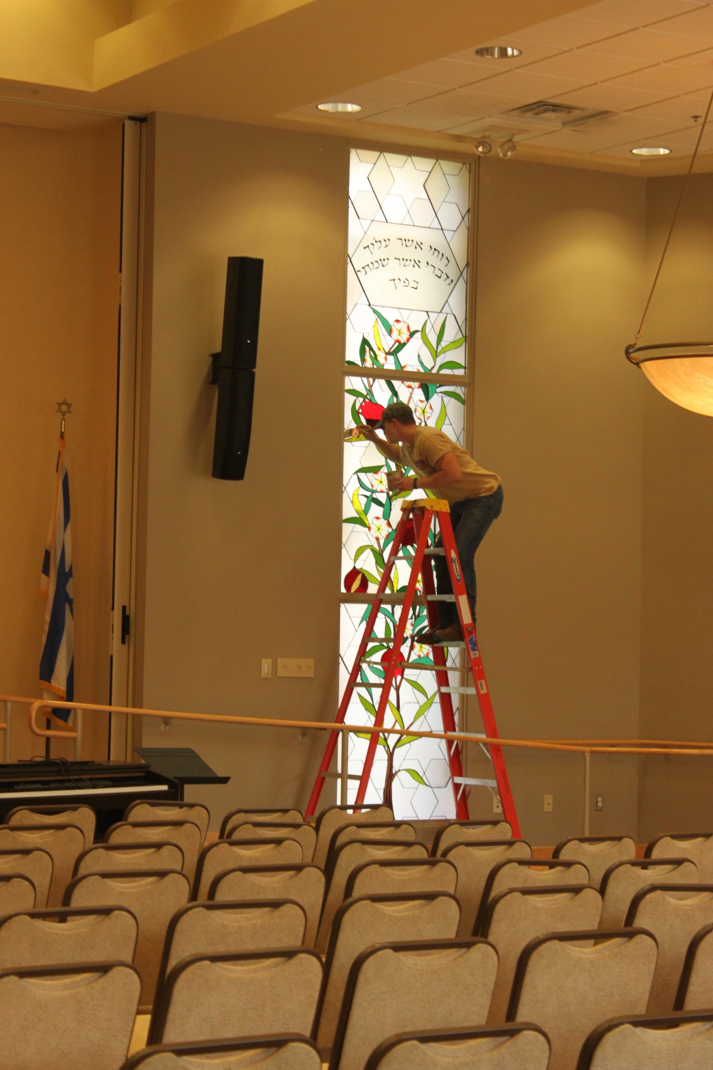 Nick touches up the painting on the new frame around the pomegranate panels.