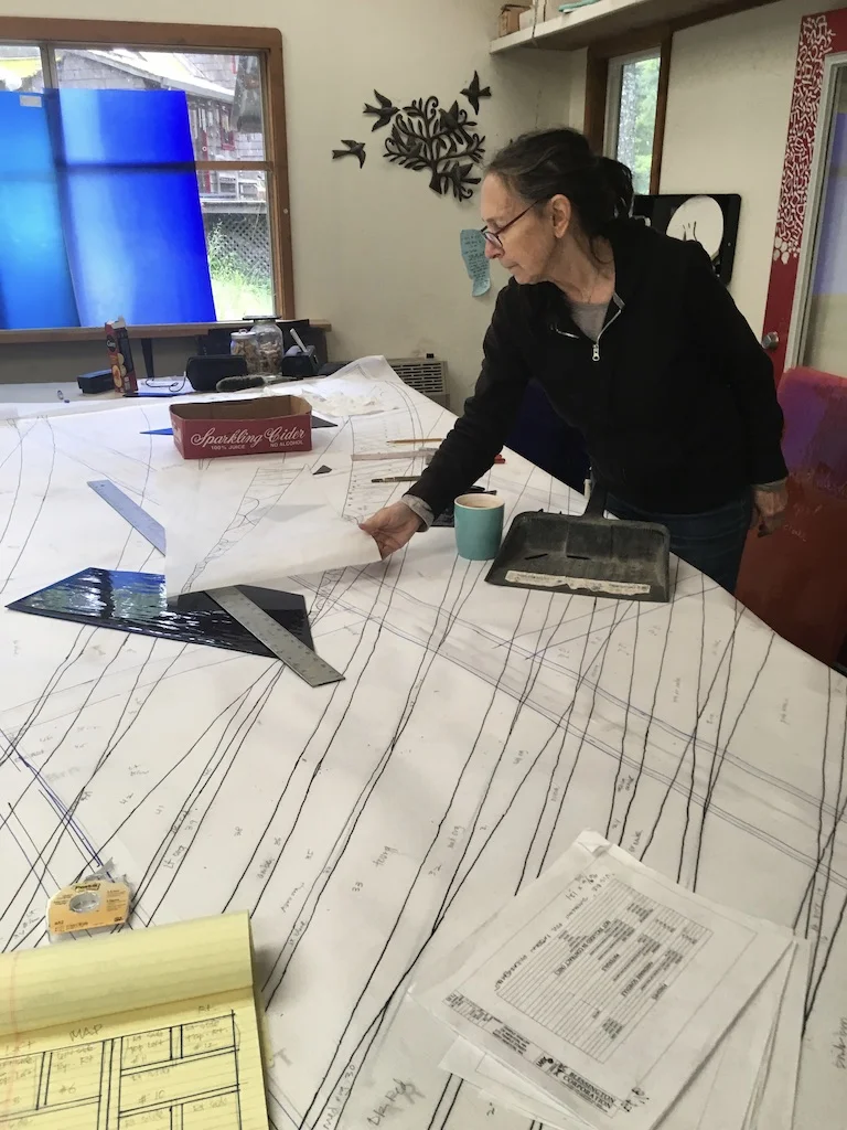 Michelle is working on the full-size pattern, choosing colors and cutting pieces.