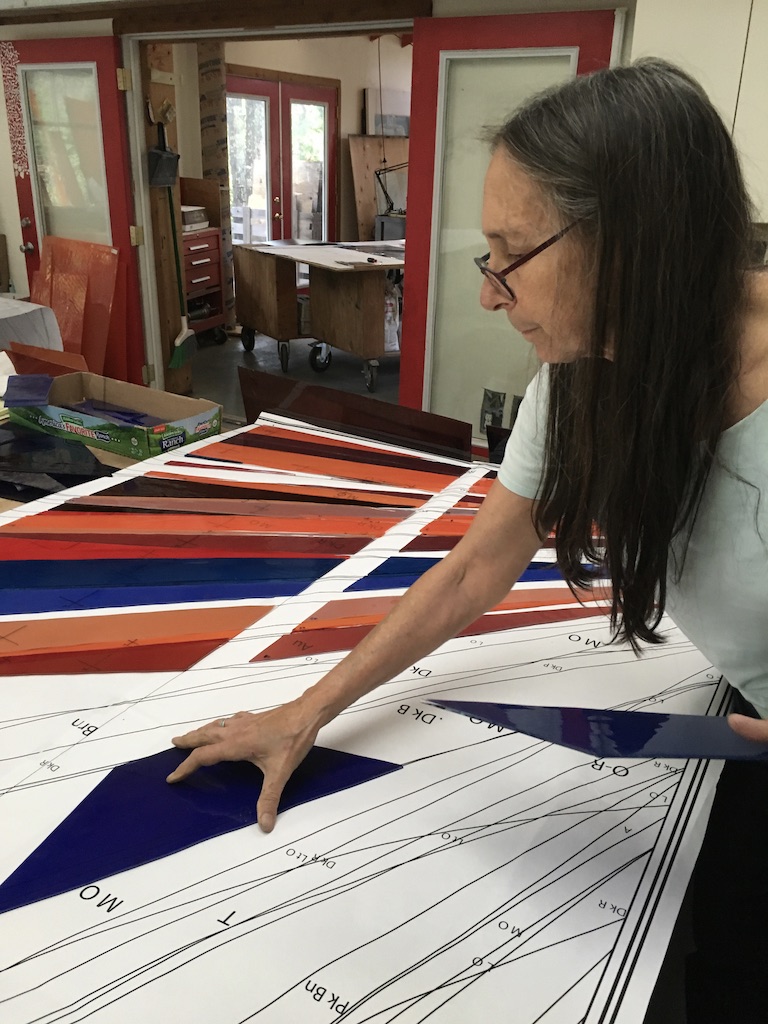 Michelle lays a completed piece on the second pattern.