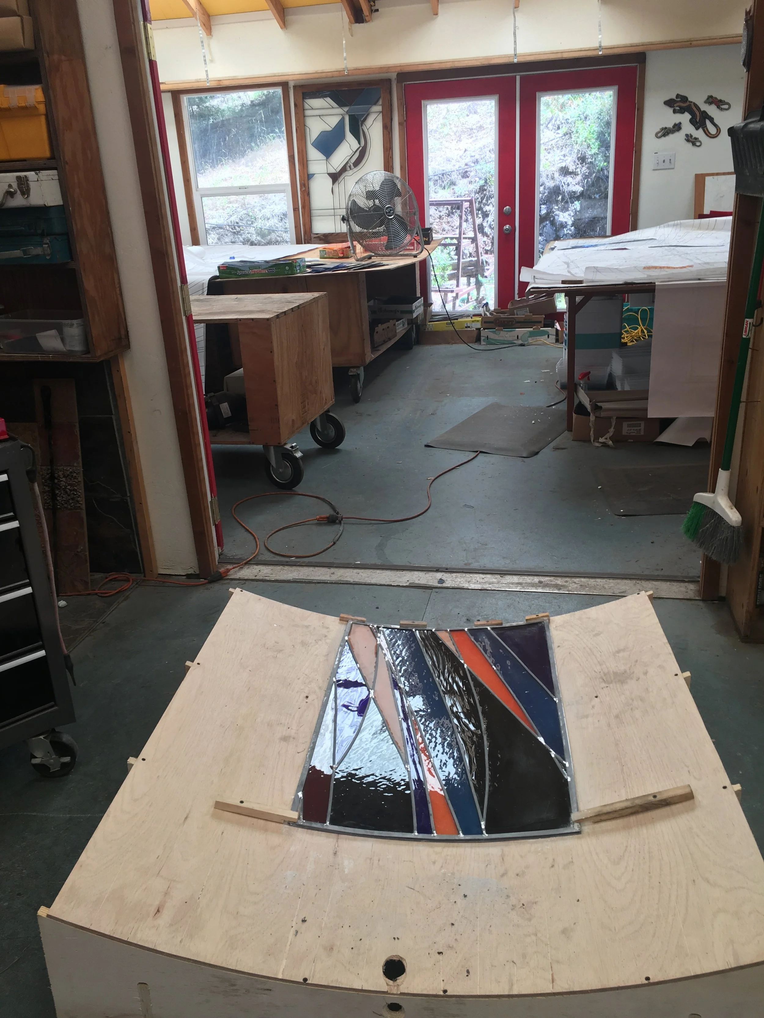  A panel rests on the inverse board, ready for soldering and glazing on the reverse side. 