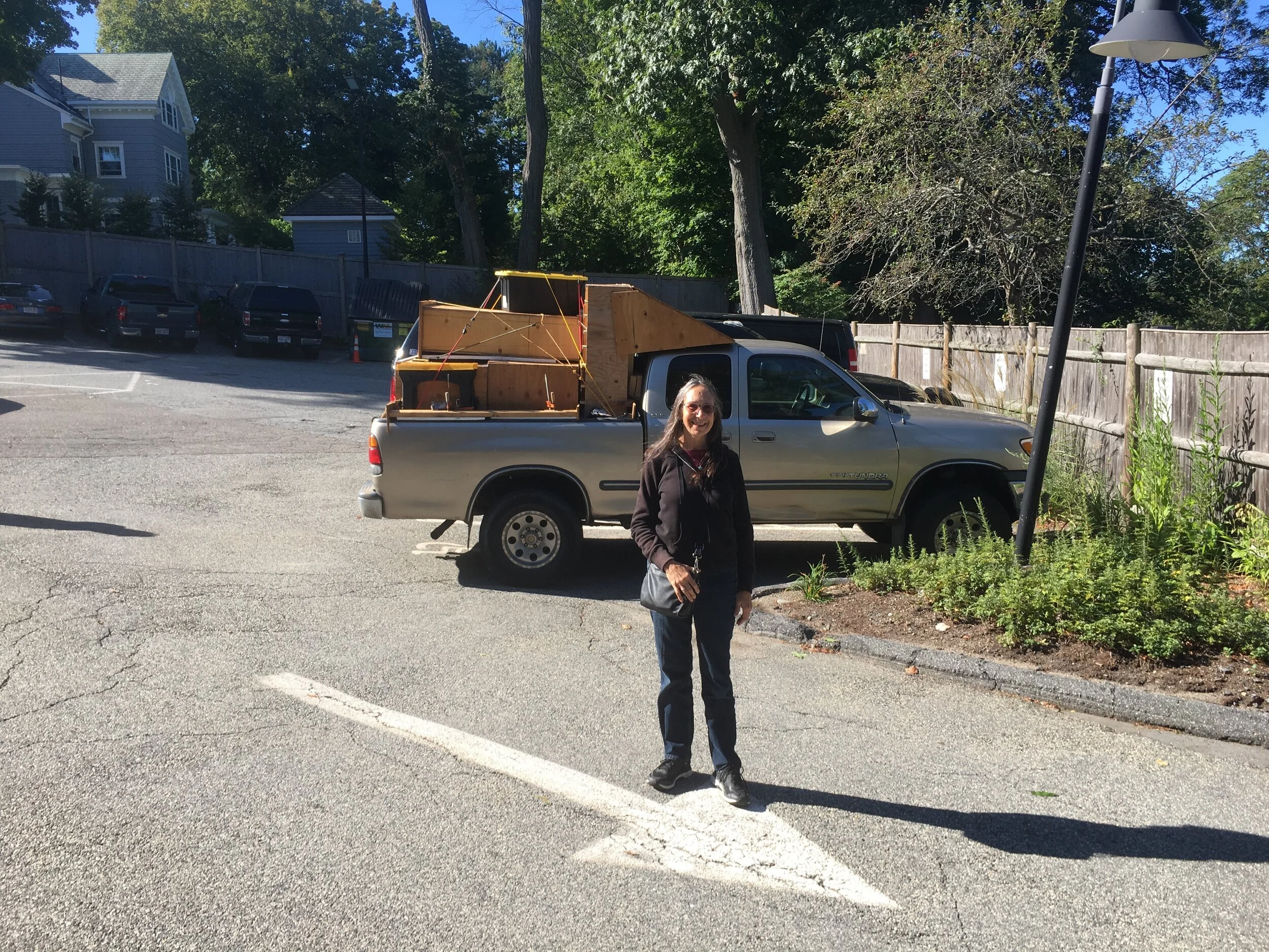  Michelle poses with our truck and load in the parking lot at Temple Shalom. 