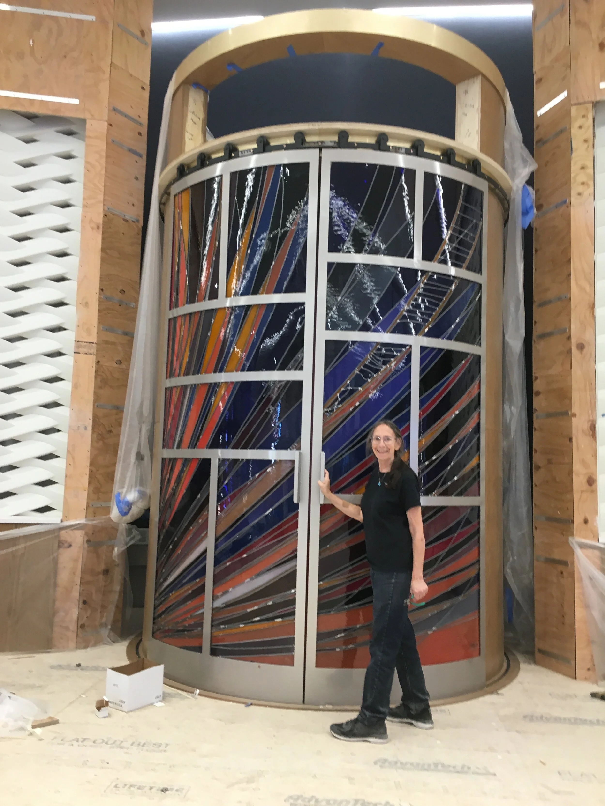  Michelle tests the door for ease of opening once the glass has been installed. 