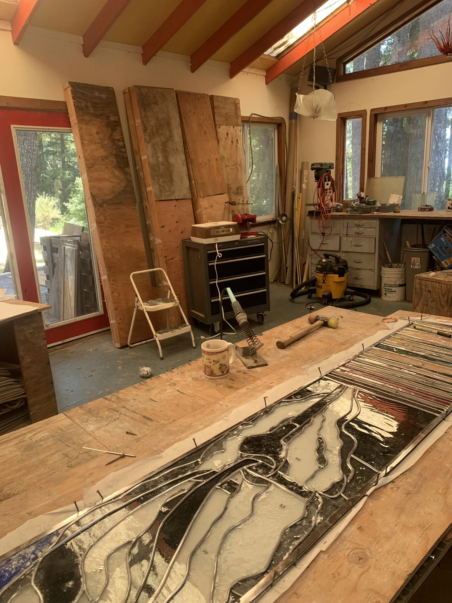 Completed panels in their crates lean against the wall awaiting delivery and installation