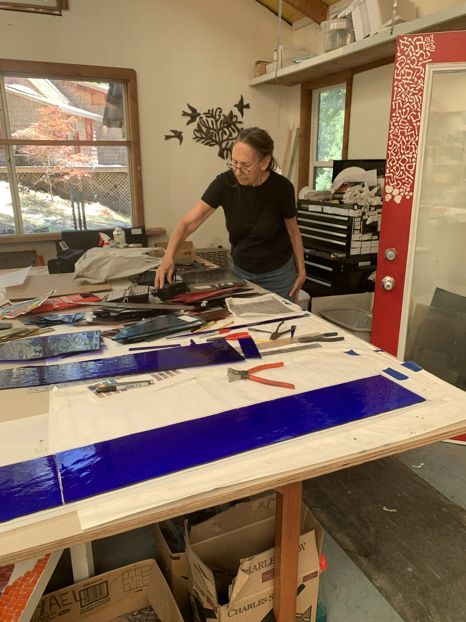 Michelle cutting the glass for the transom window