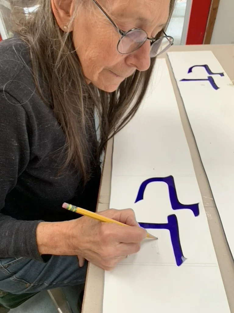Michelle cuts the resist, in preparation for sandblasting of pieces for Panel #9