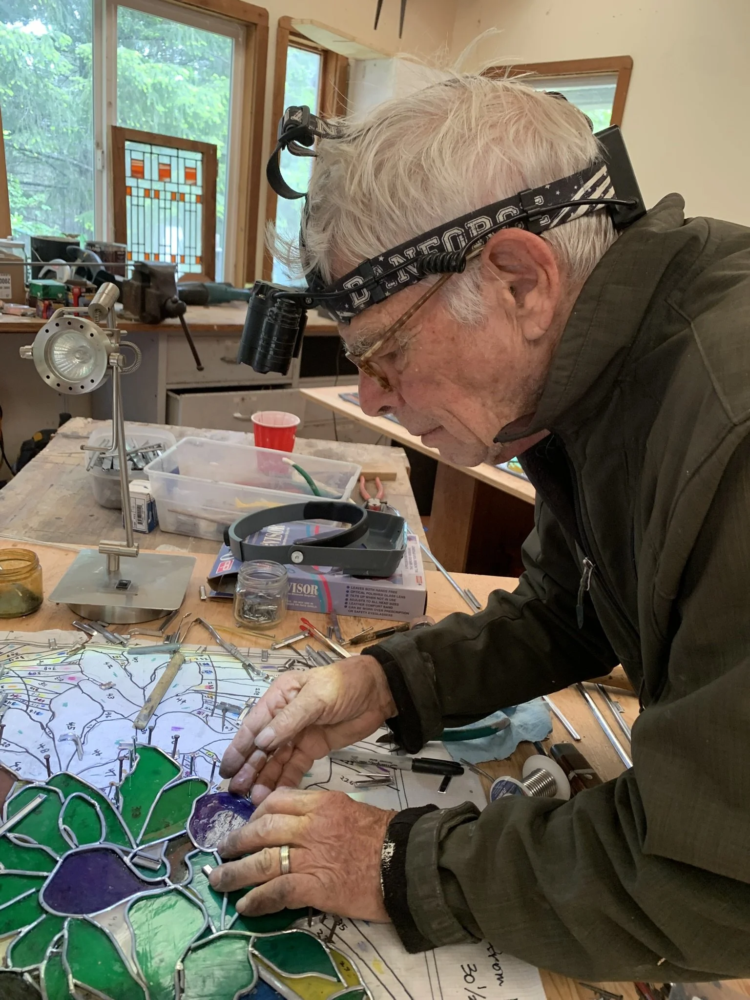  David works on the intricate assembly of the fig tree panel 