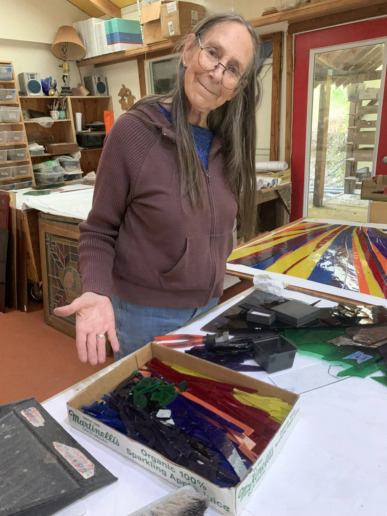  Michelle gestures to her box of very tiny scraps of glass 