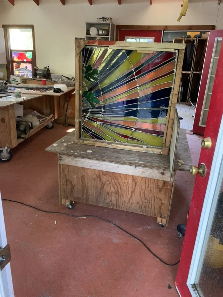  Cleaning the backside of this sidelight panel in the central window group 