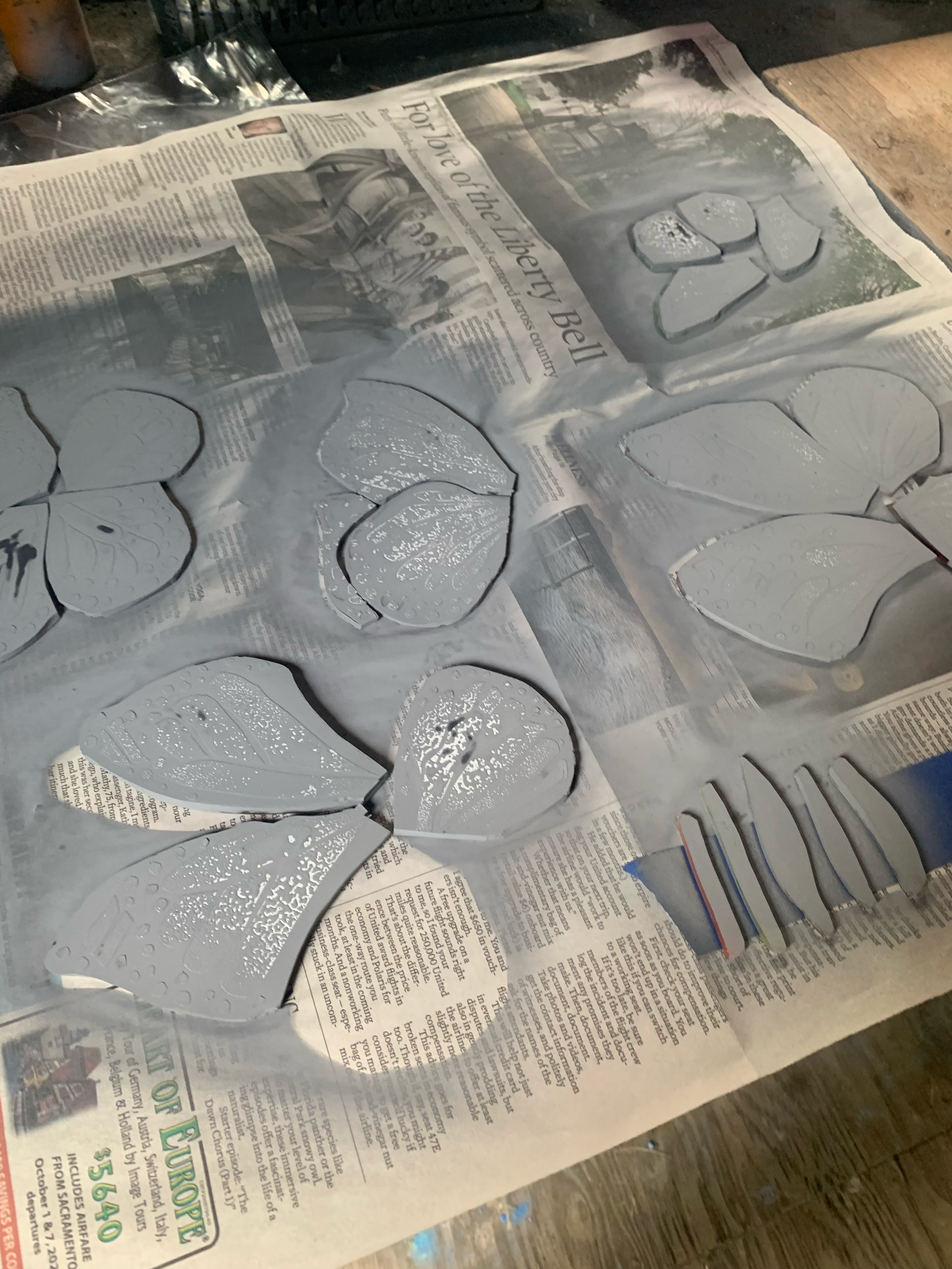    the butterfly pieces are brought back from the air brush table to have resist removed 