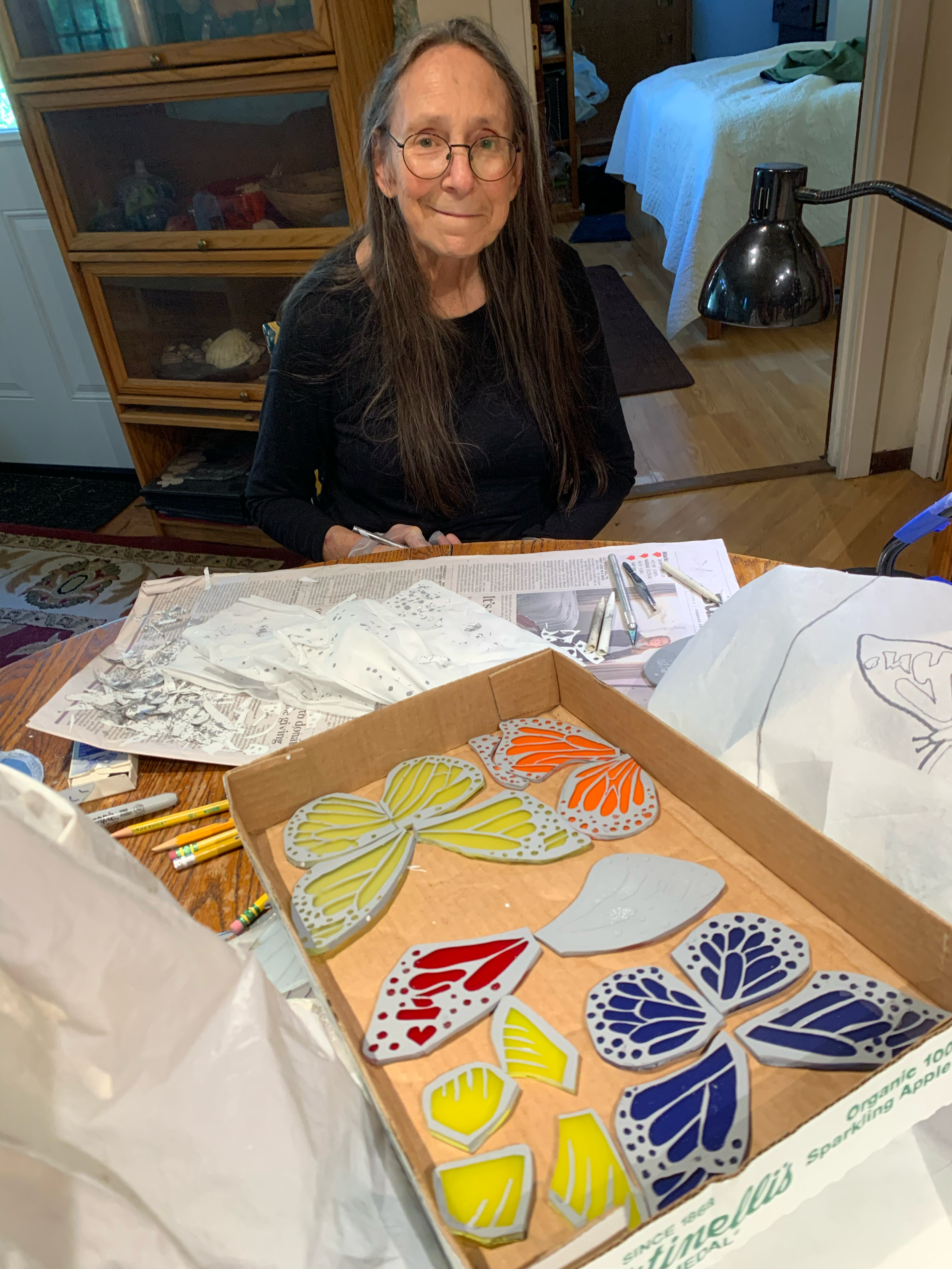  Michelle removing the resist from the buttderfly pieces ready to fire 