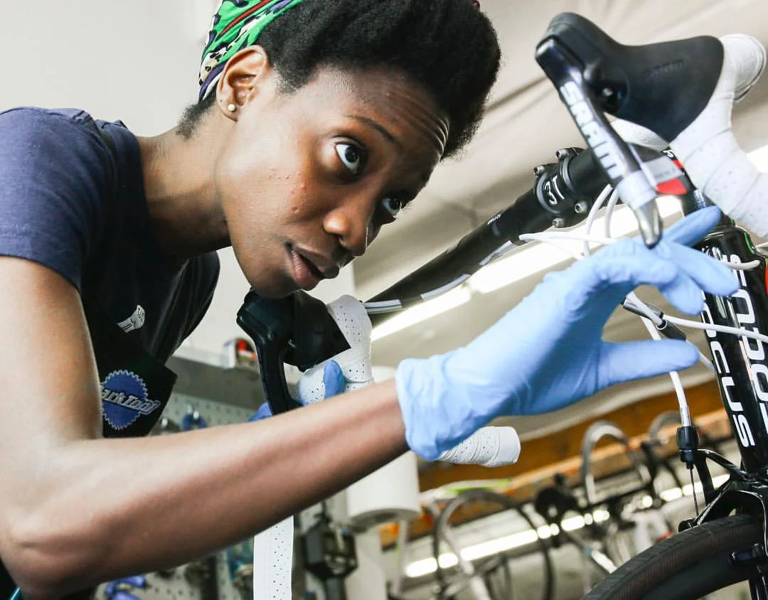 Photo by Sam Stember . Laura being a badass bike mechanic.