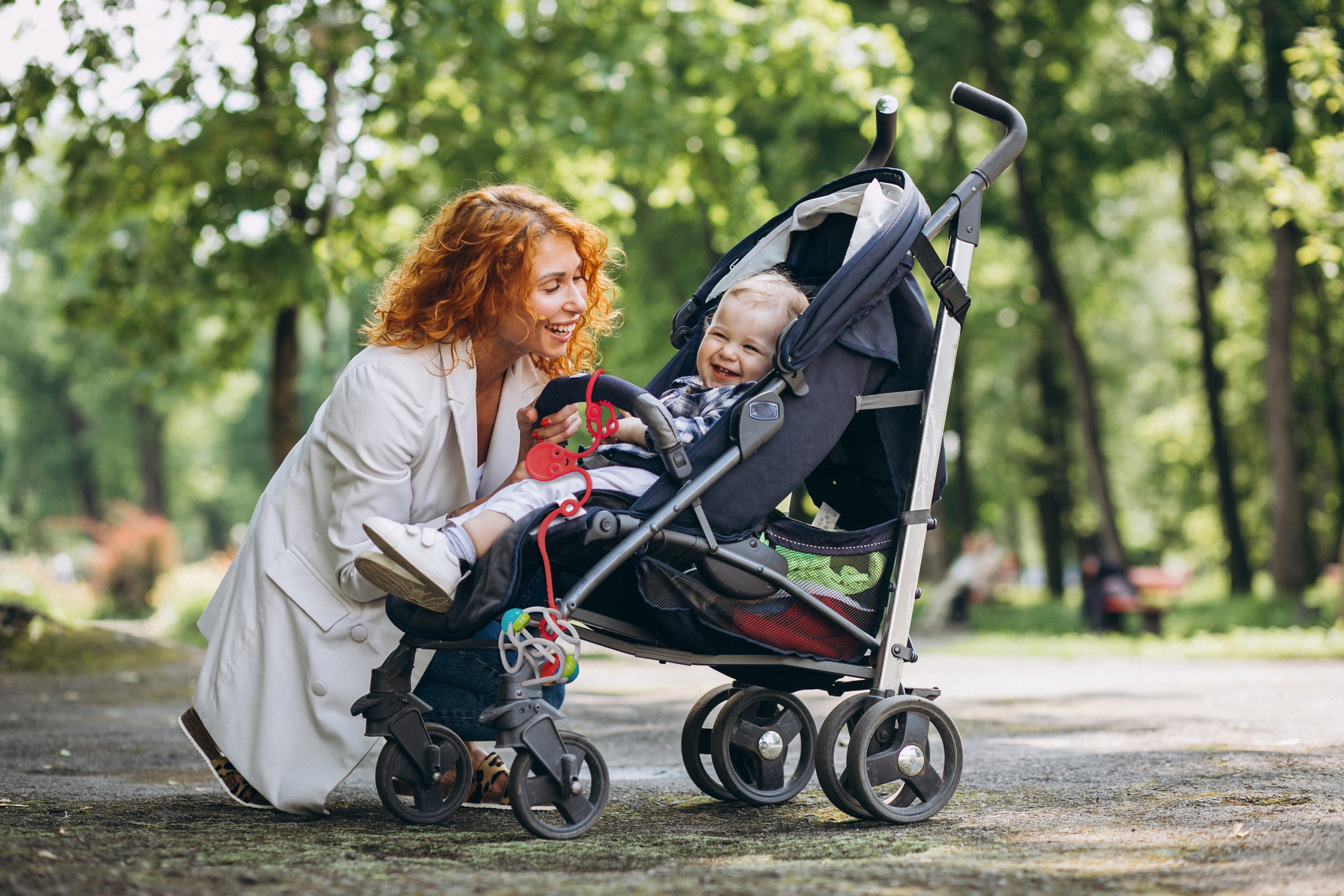 mother-with-her-little-son-baby-carriage-park.jpg