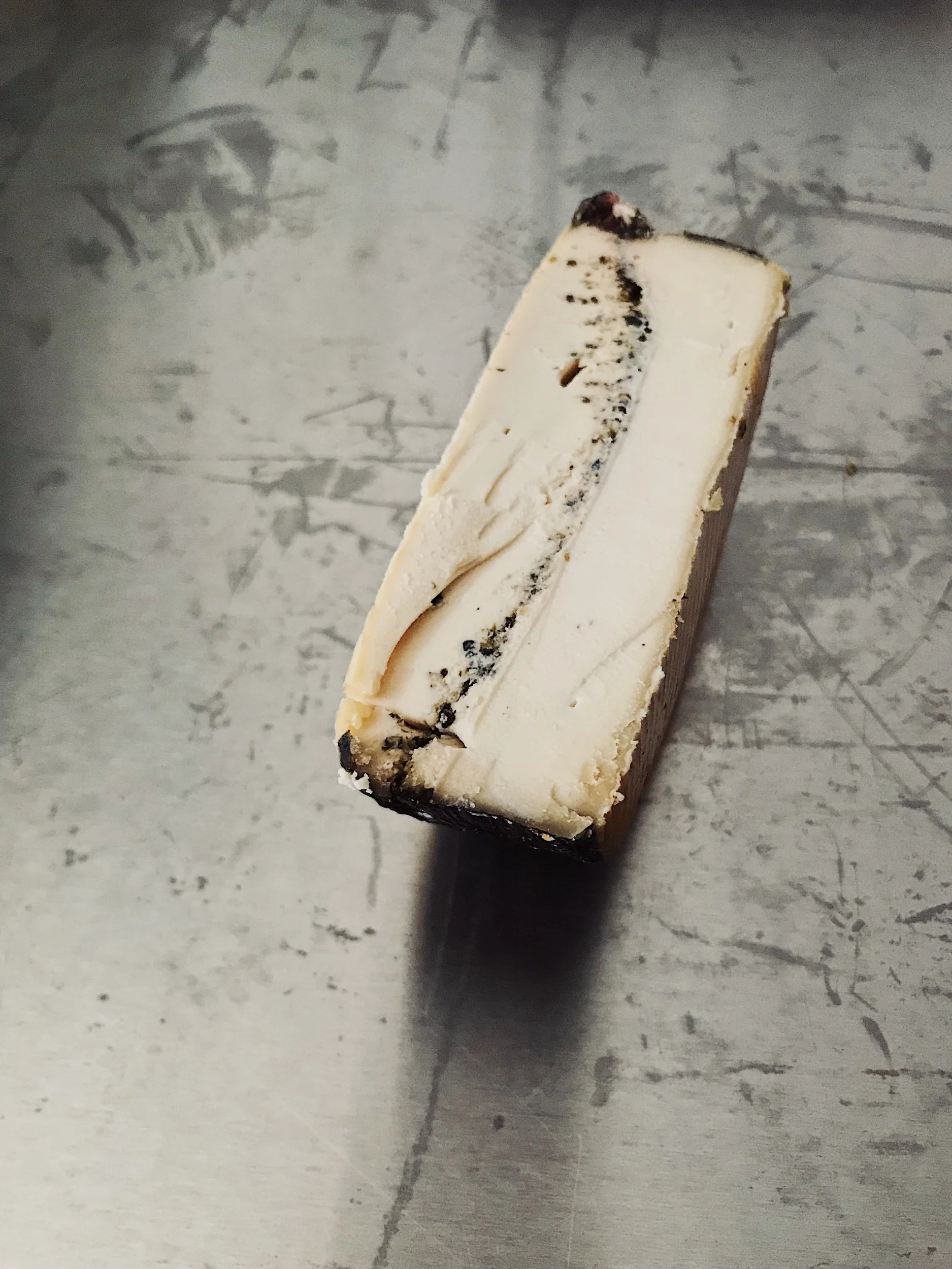 Nori Cendré: our most popular nut-milk cheese, aged in a nori leaf with a black sesame and cumin ash line.