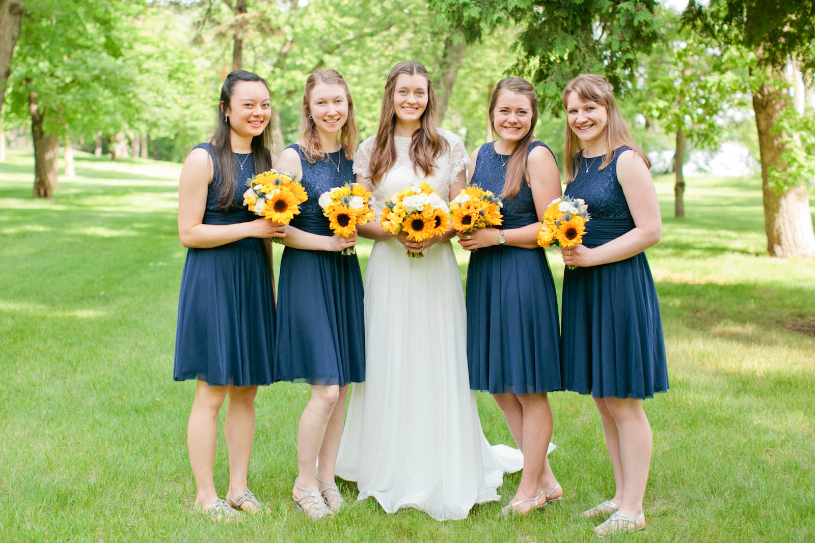 bride and bridesmaids outdoor minnesota wedding photographer