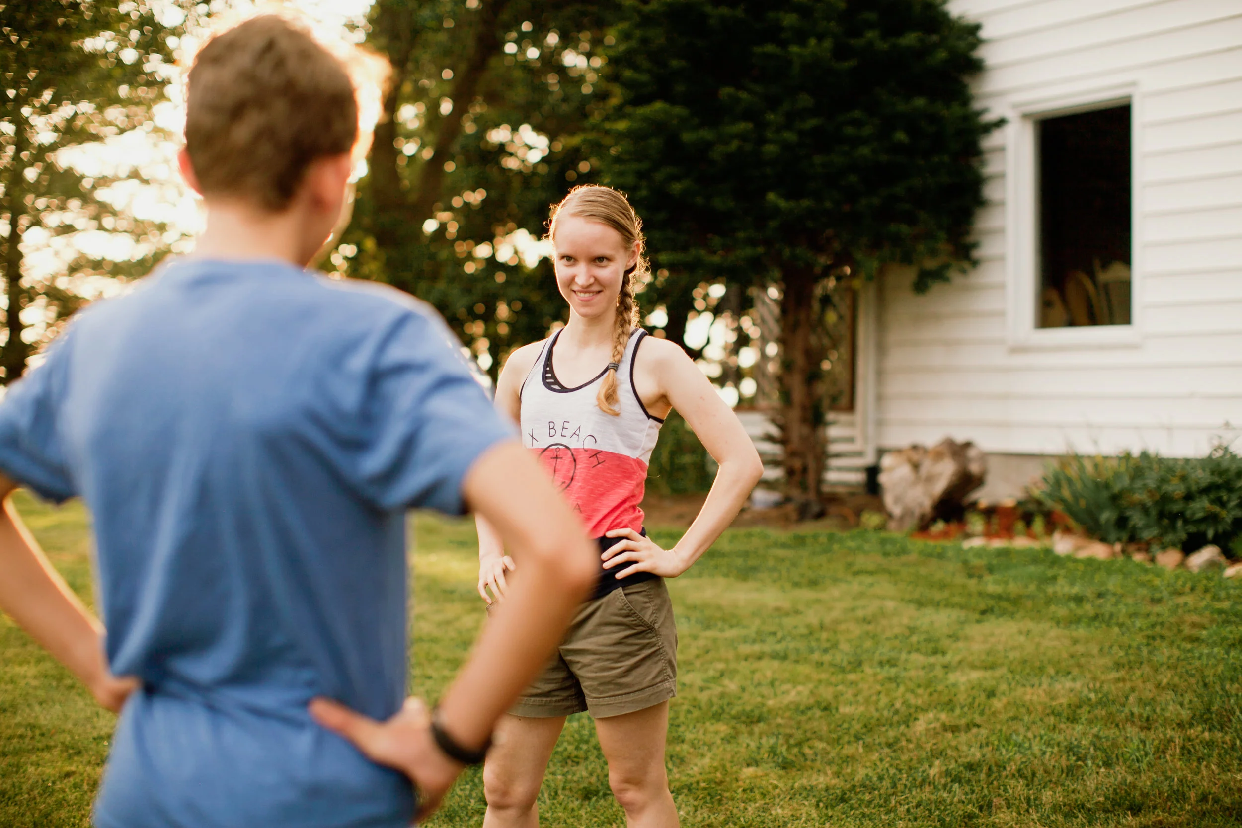 brother and sister playing game on farmland in Iowa