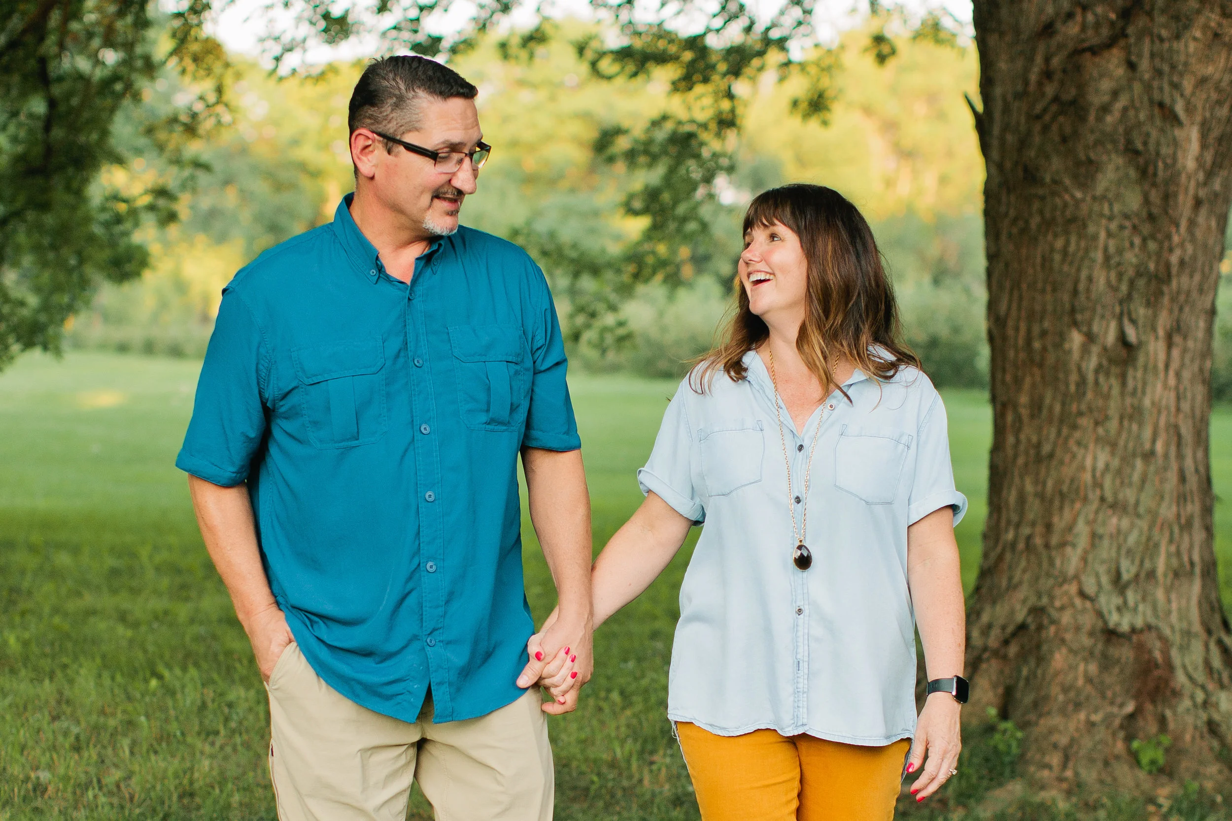 parents holding hands and walking family photos Des Moines