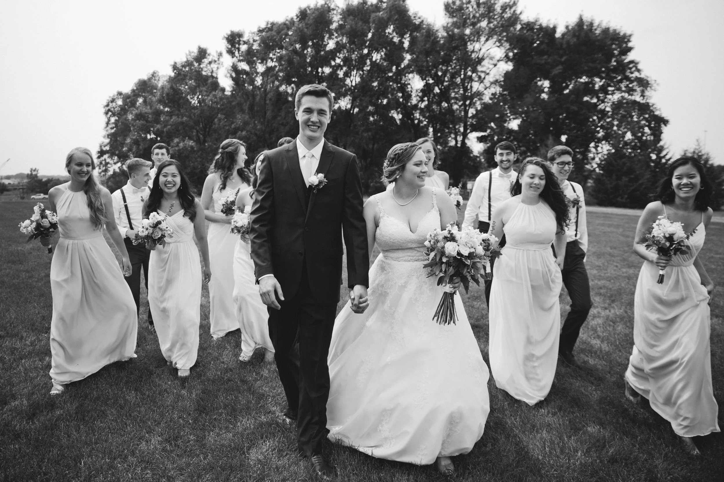 bridal party in des moines park celebrating wedding