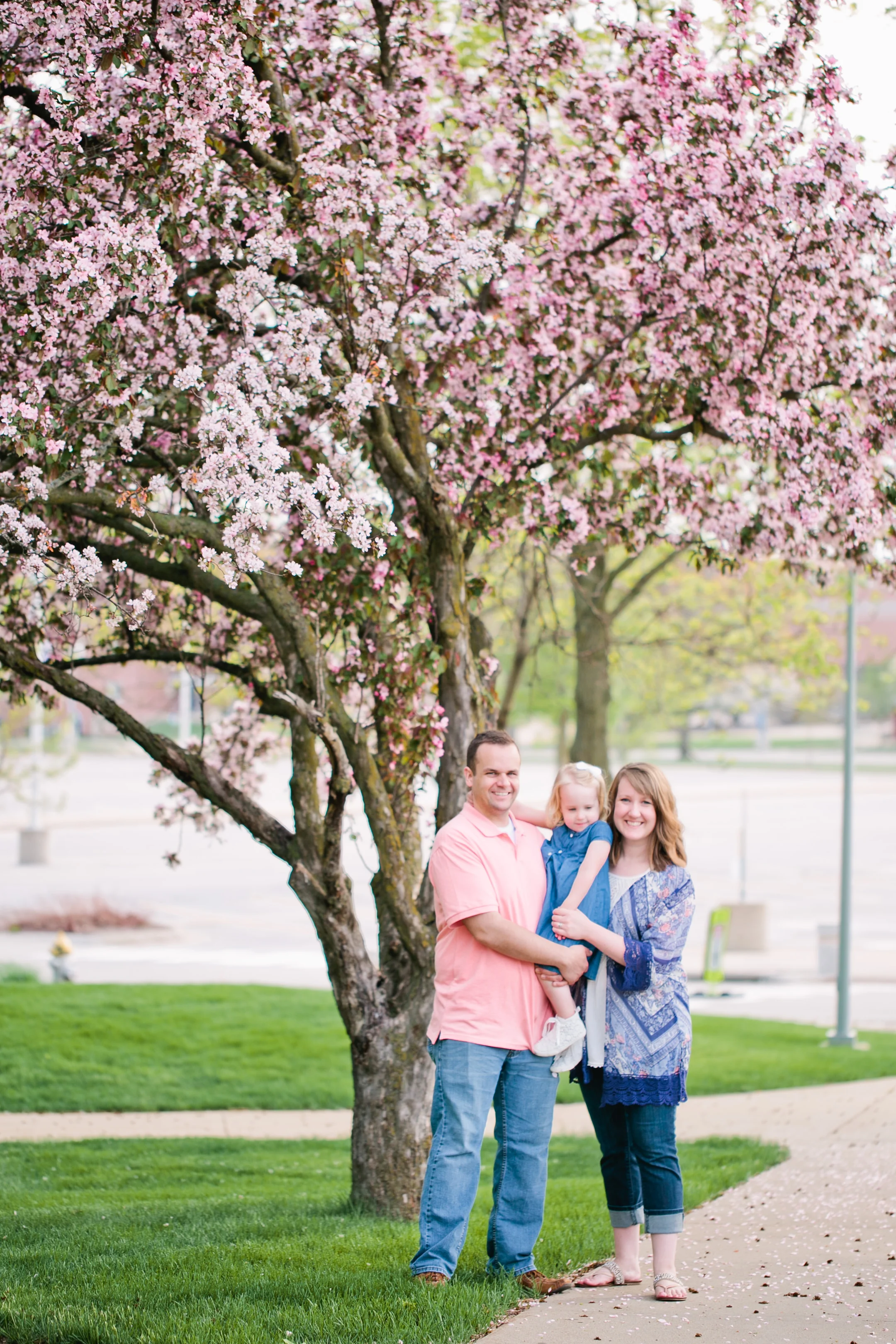 family standing under flowering tree cedar falls spring photos