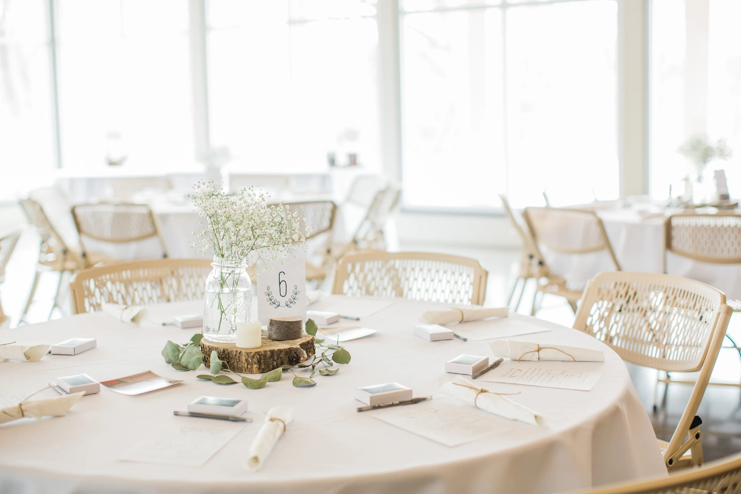 wedding reception decor white and green with babys breath and eucalyptus