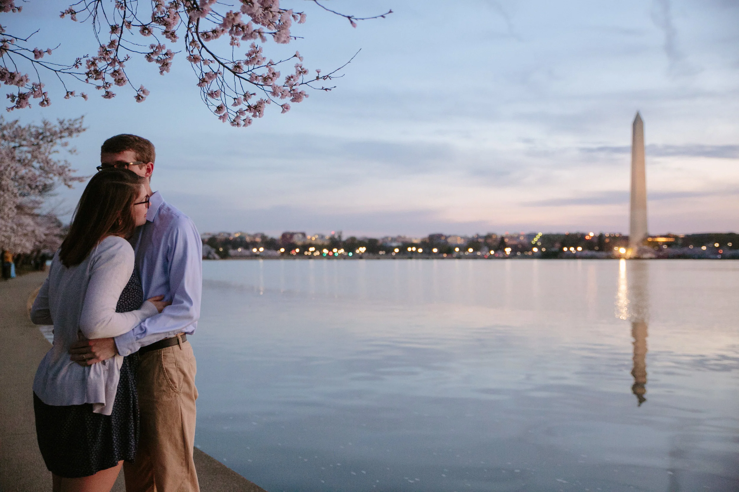 sunrise engagement photos at tidal basin during peak bloom cherry blossoms