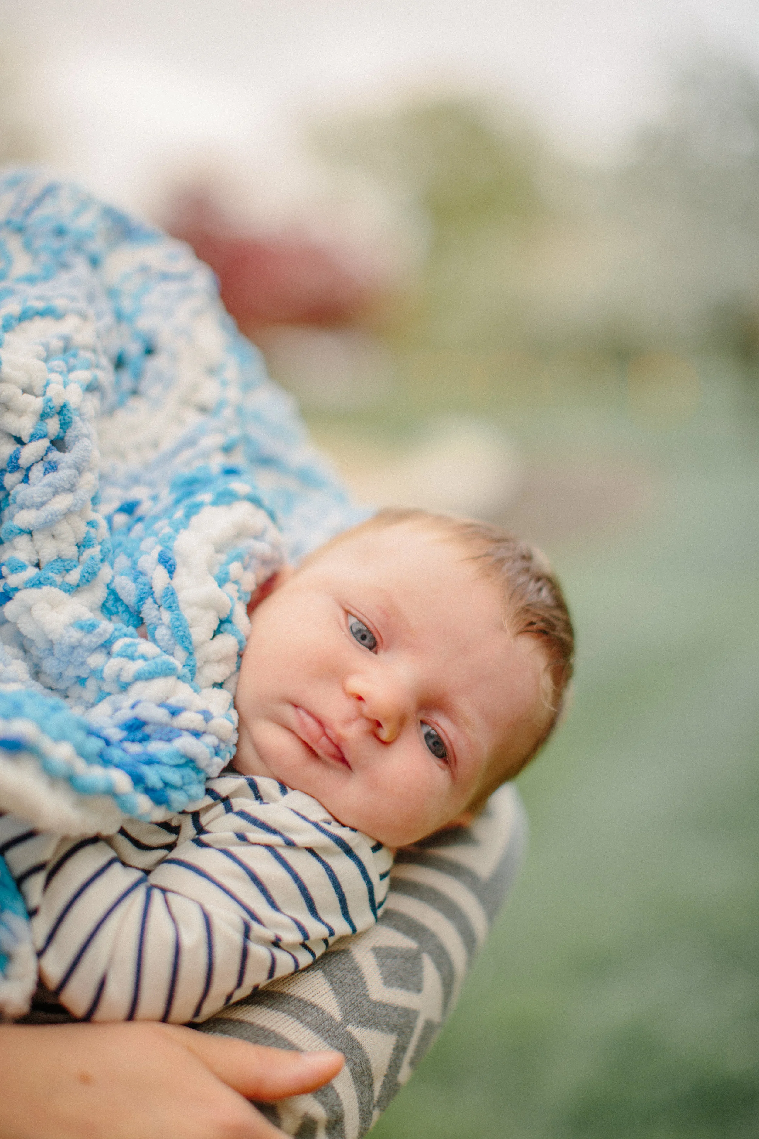 newborn baby boy in mother’s arms