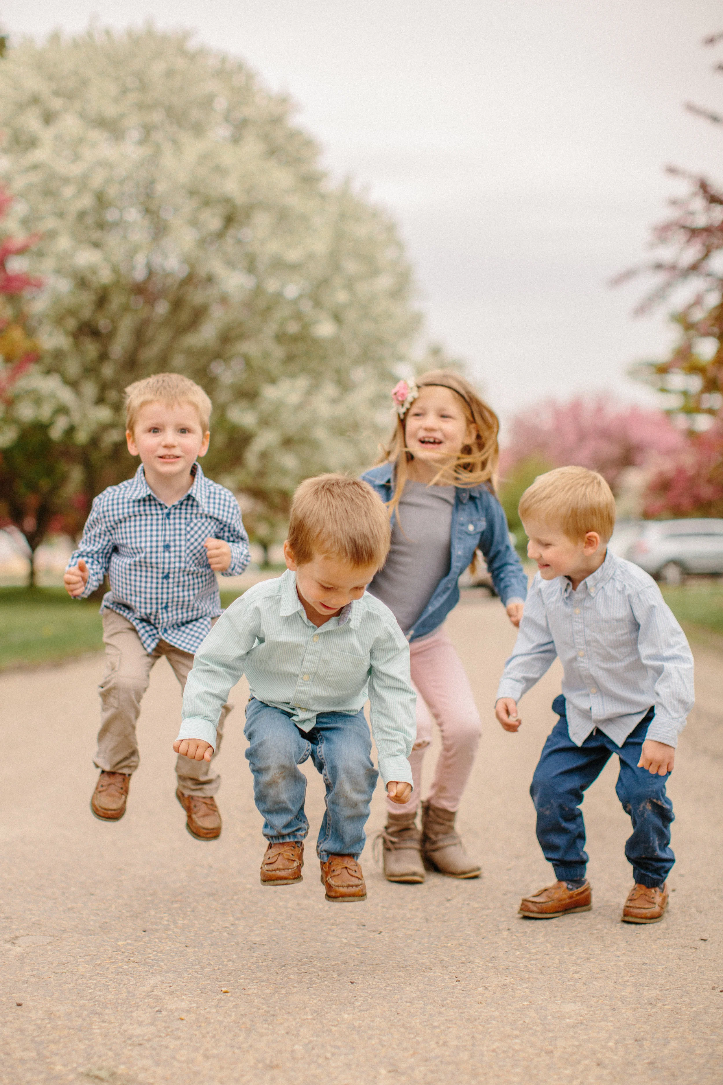 kids jumping for family photos in Des Moines Iowa