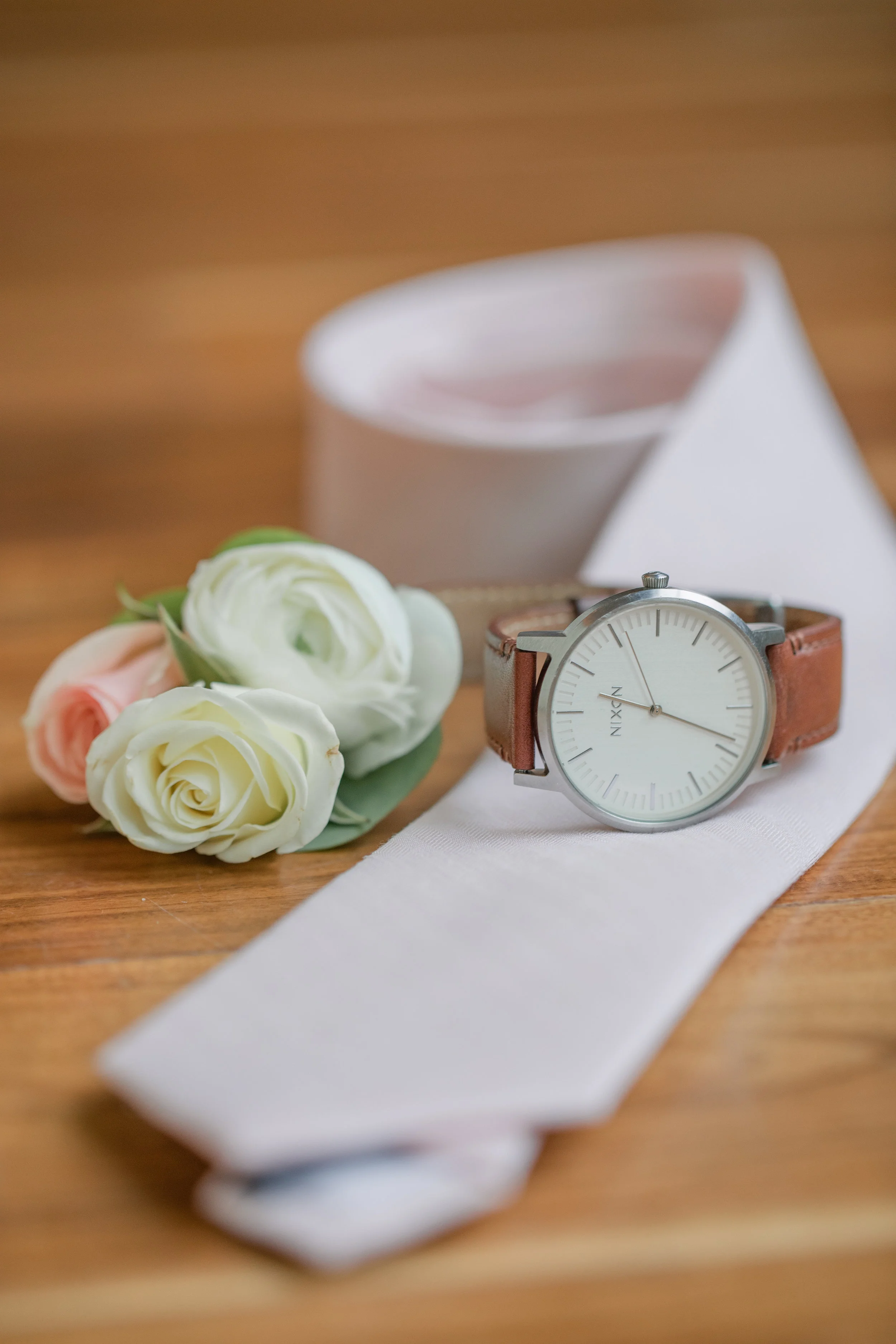 groom’s flowers corsage and tie with watch
