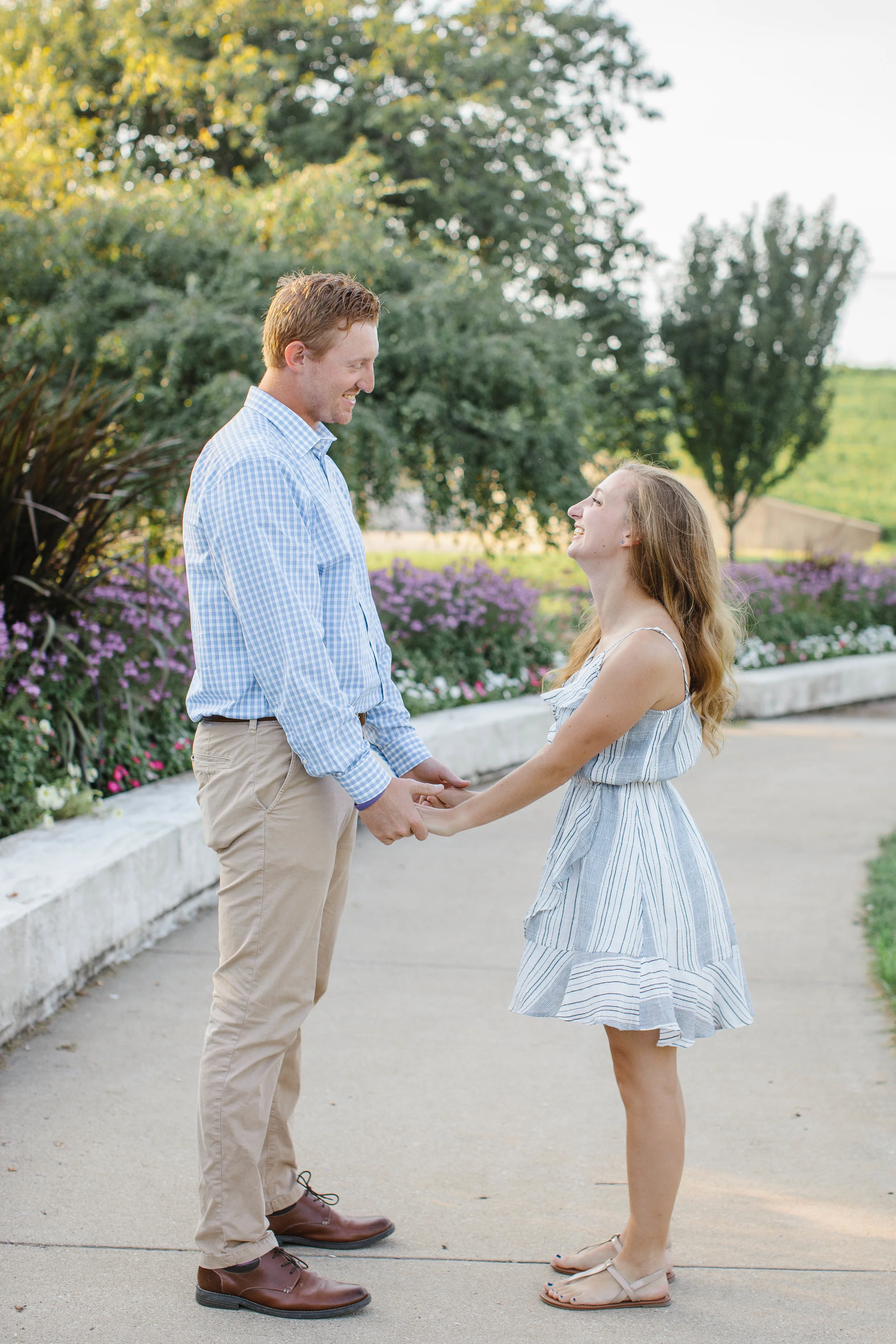 holding hands in the park engagement photos