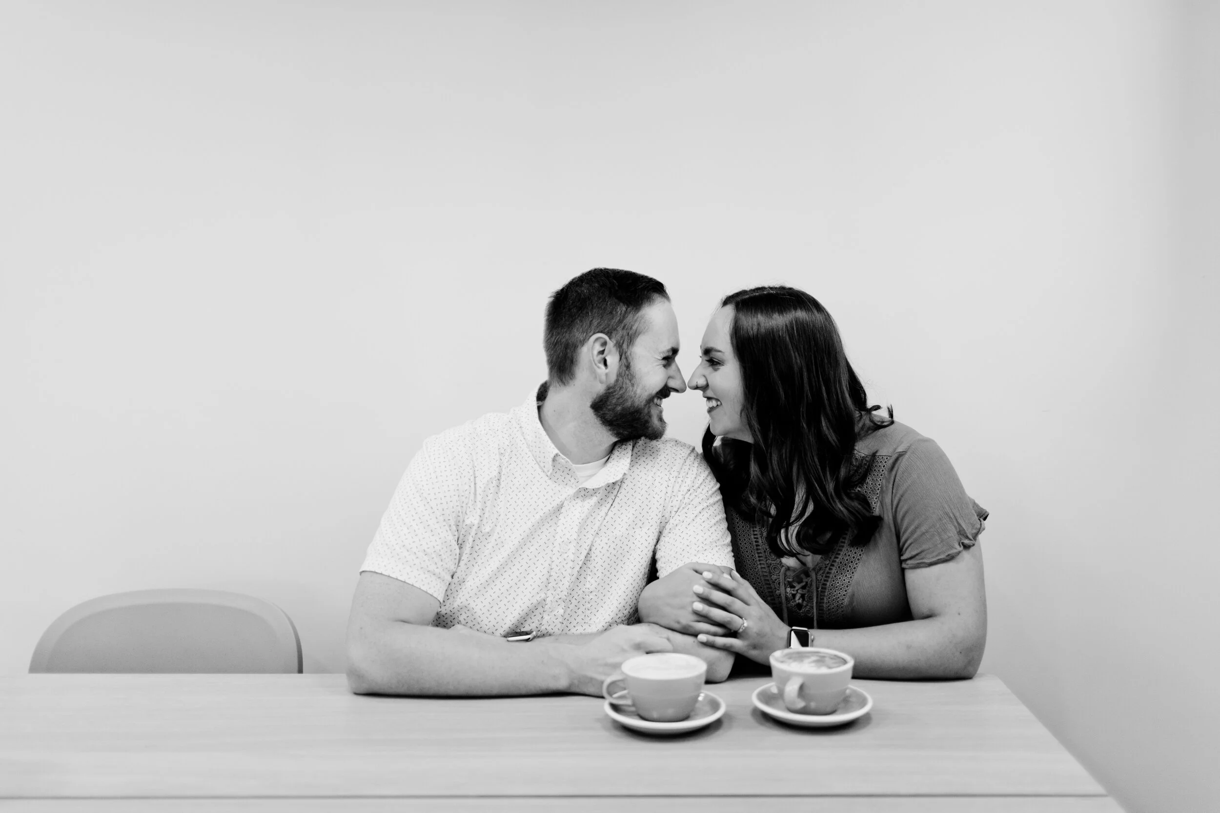 couple in coffee shop black and white photo why pick engagement photos wedding photographers