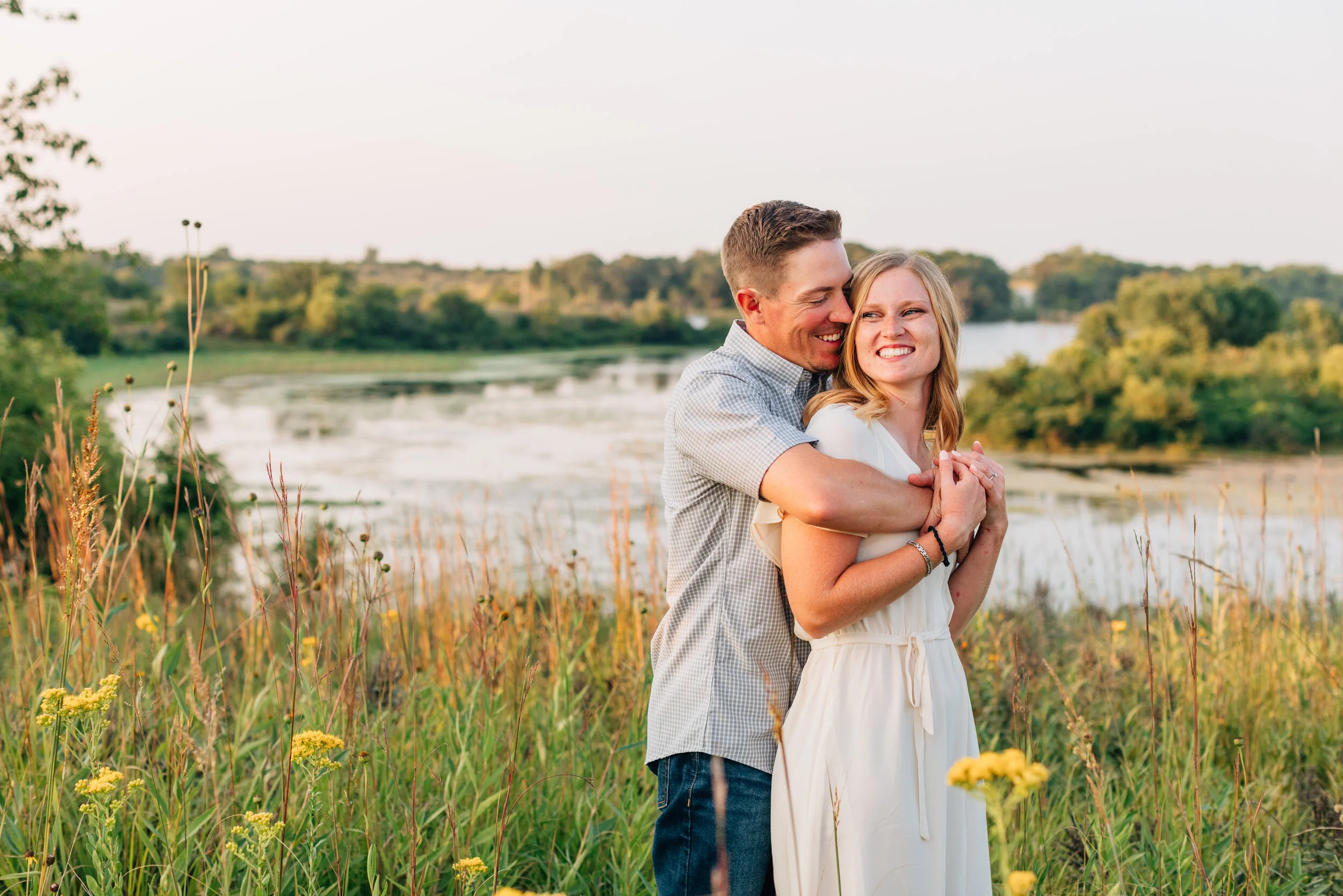 couple in prairie grass engagement photos