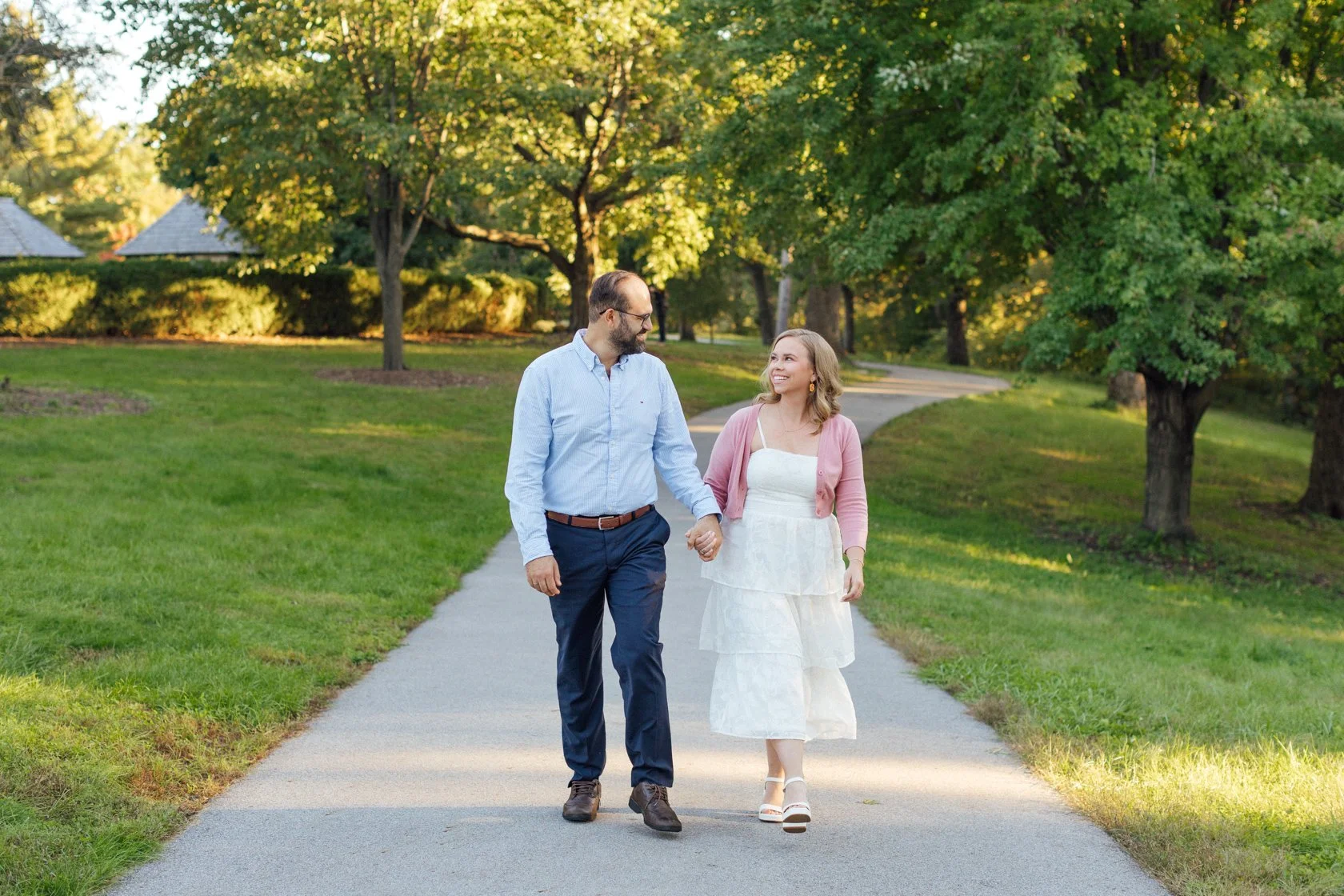 couple walking holding hands fall engagement pink white blue outfits