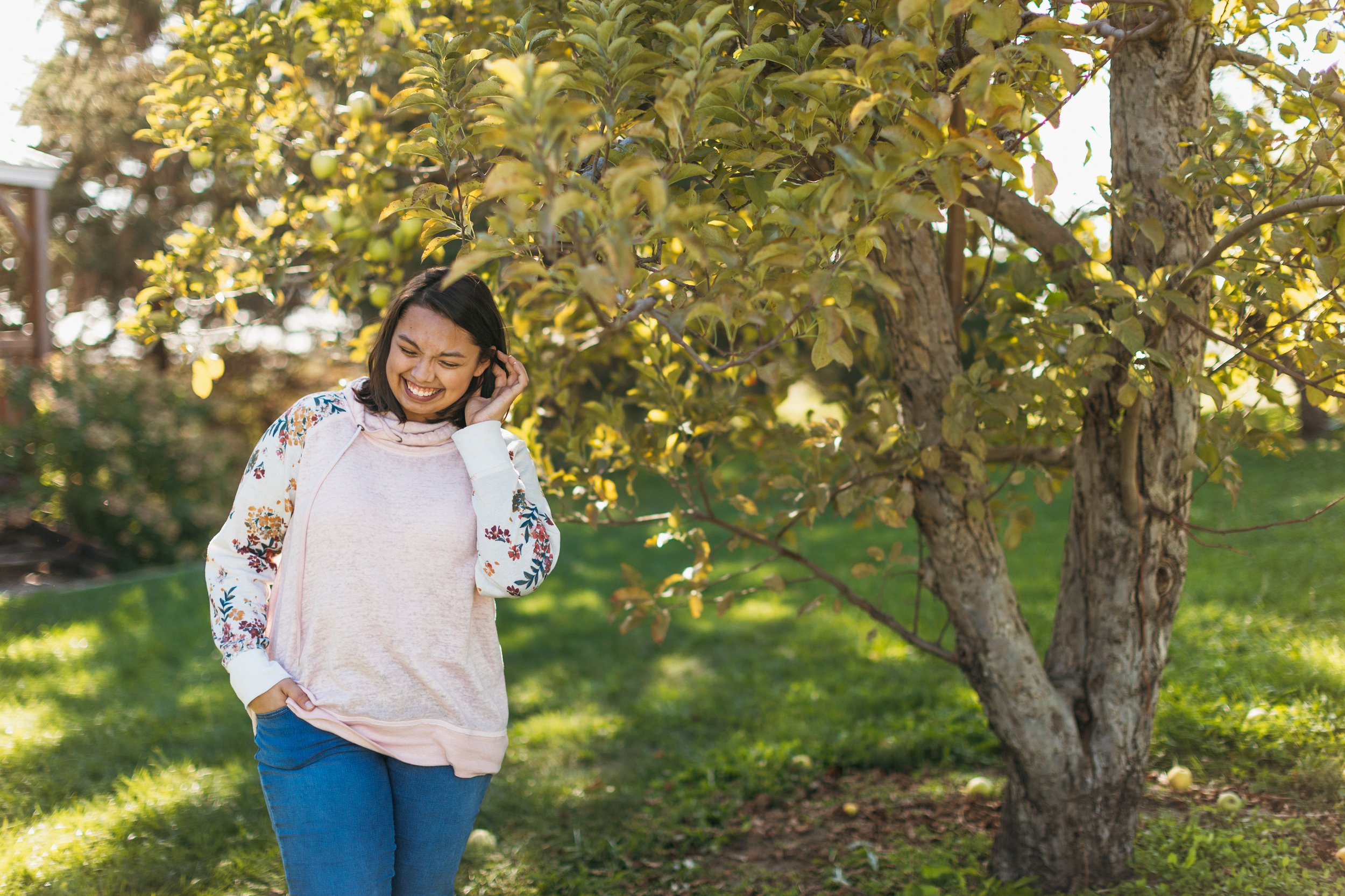 senior girl giggling fall session at orchard