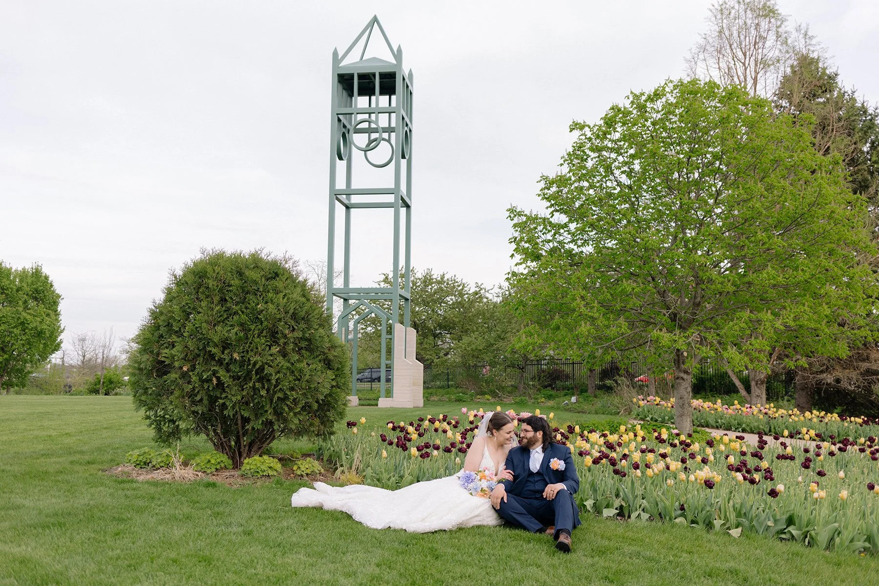couple sitting in front of tulips campanile reiman wedding