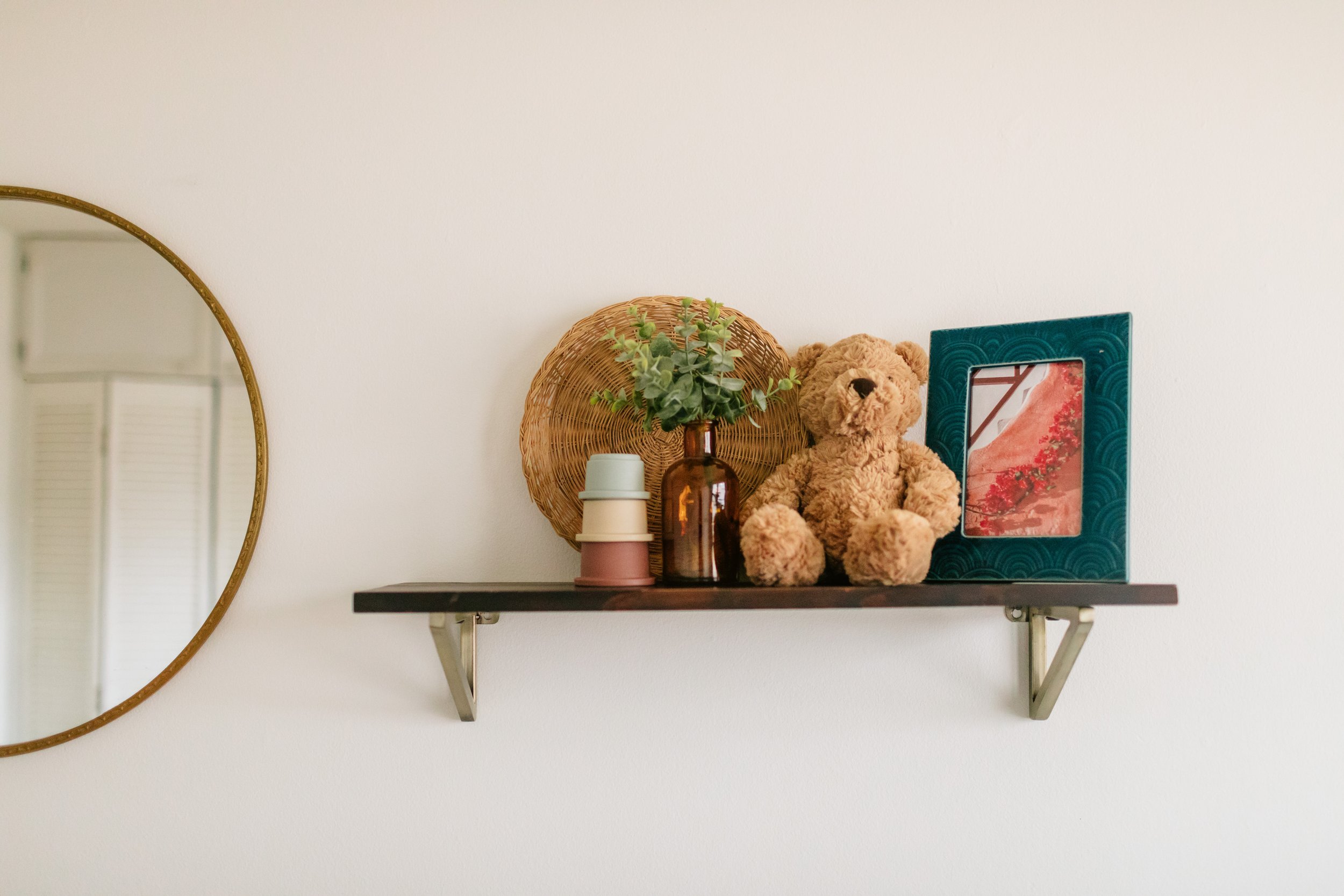 toys and decor sitting on shelf in nursery