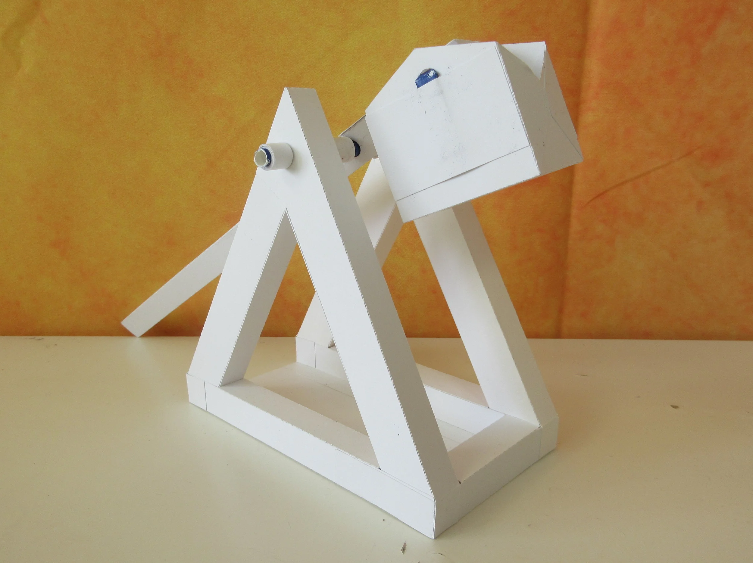 This trebuchet catapult was designed with 110lb cardstock to survive the forces of the counterweight and throwing arm!