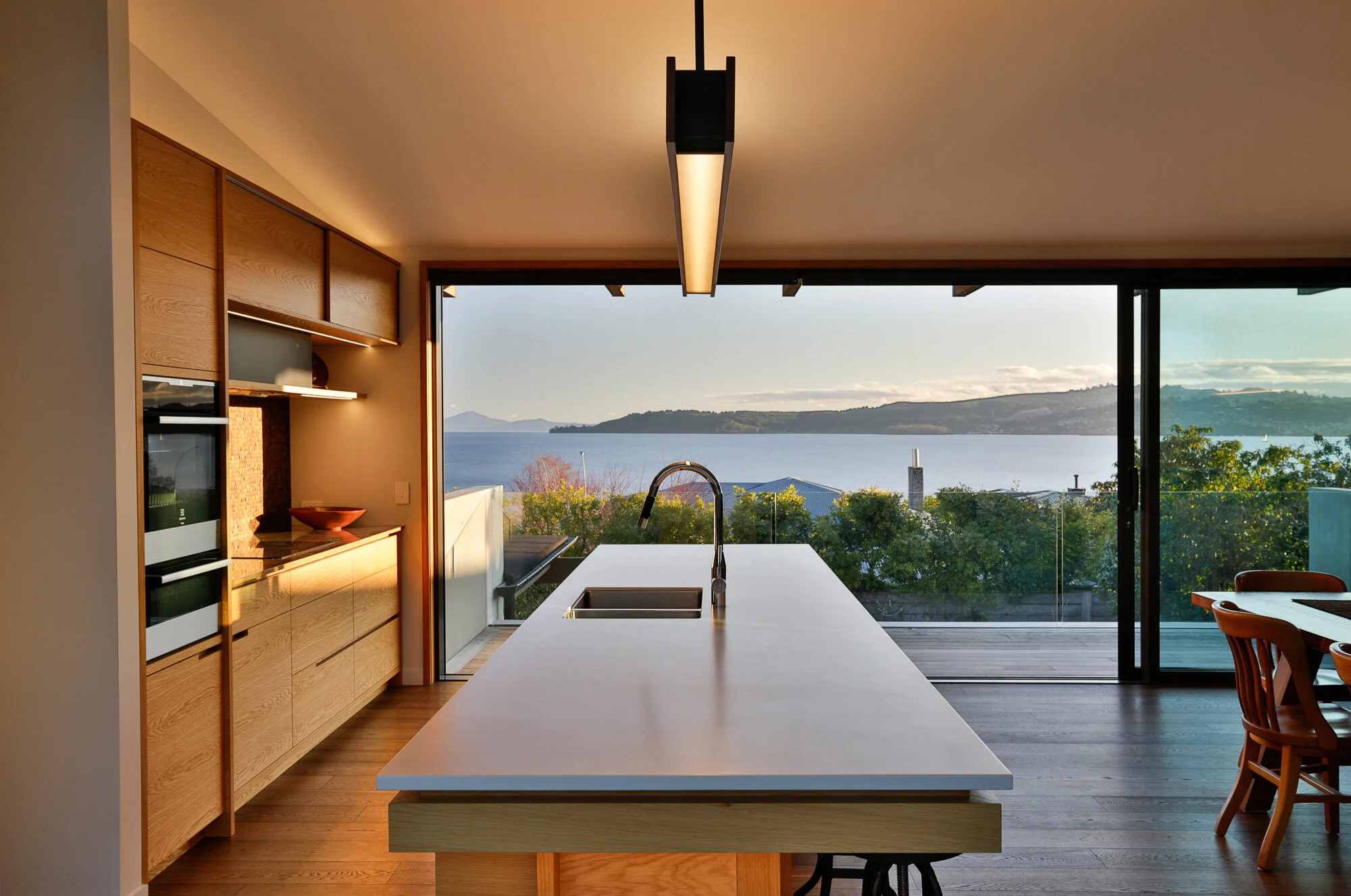 Kitchen with lake view designed by Fraser Cameron Architects Taupo. Taupo Architects Fraser Cameron Architects. New Zealand Architects. Haimes Building Taupo. Architectural Builders Taupo. Central Plateau Architects. Taupo Designers. 