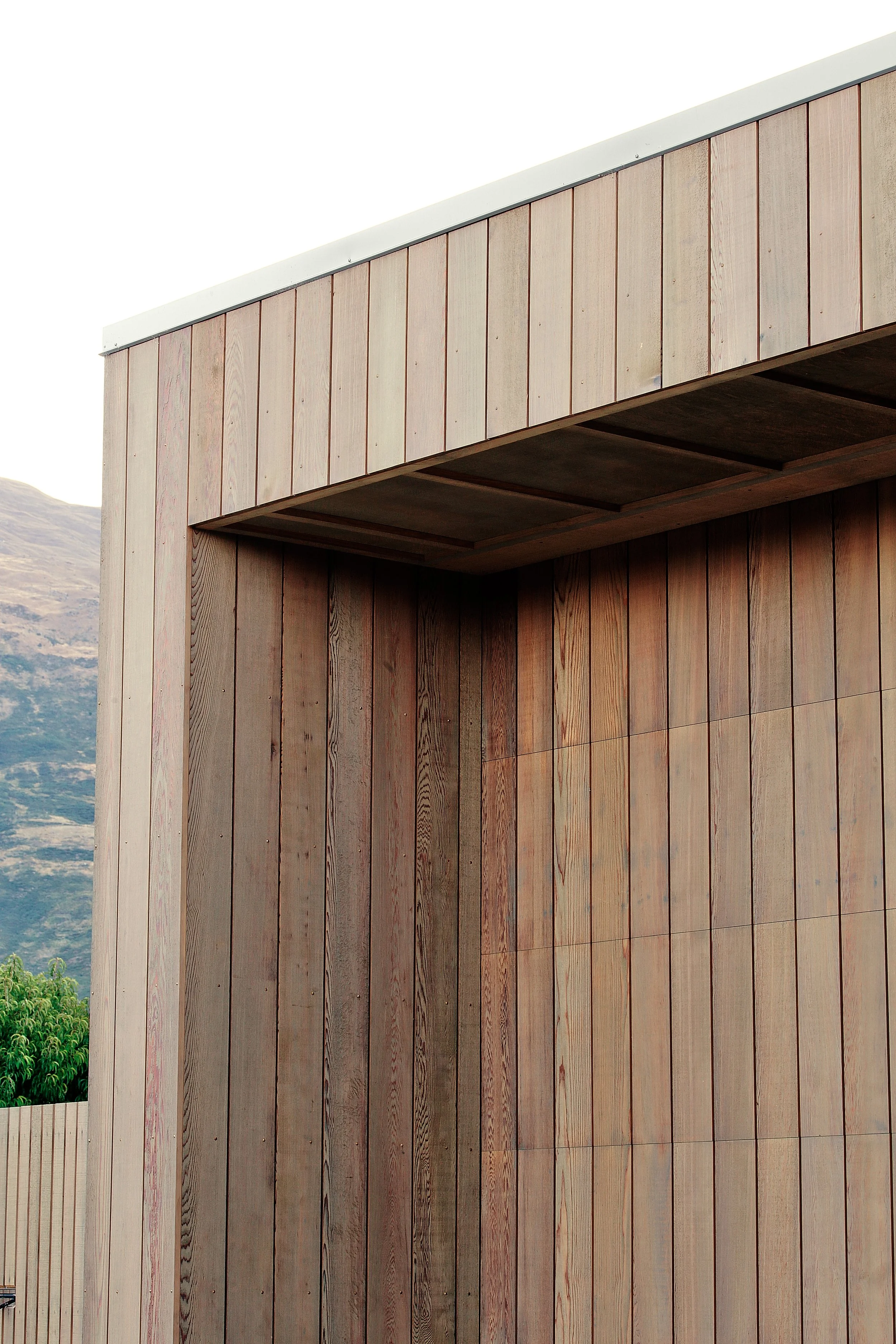 Wanaka House designed by Fraser Cameron Architects Ltd. Western Red Cedar Cladding Garage Door. 