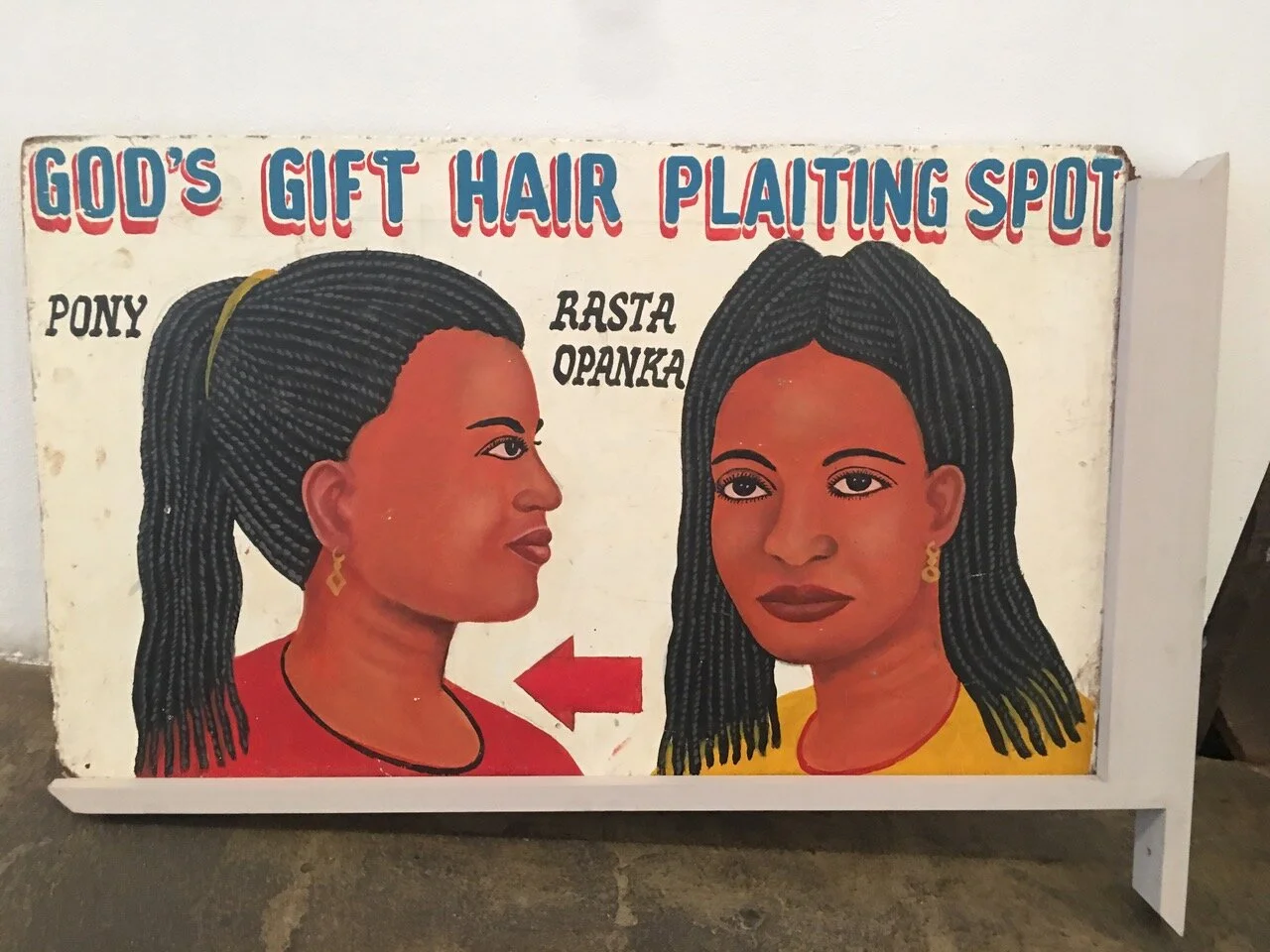 God's Gift Hair Plaiting Spot, double-sided sign, c. 1990s, Ghana, paint, wood, 18" x 32"