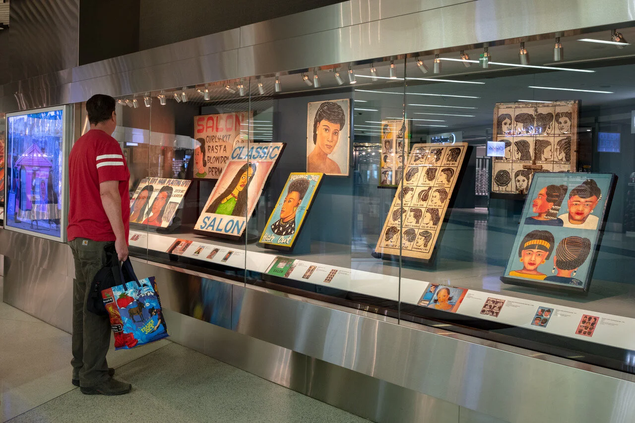 On display through September 2020 at San Francisco International Airport, Terminal 2, as part of Extra ‘O’!: African Barbershop and Hairdressing Signs