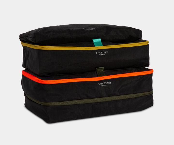 Packing cube set with pop zippers and trim webbing. The body is made of lightweight crinkle fabric.