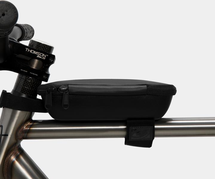 It attaches to the Head tube and top tube of the bike.