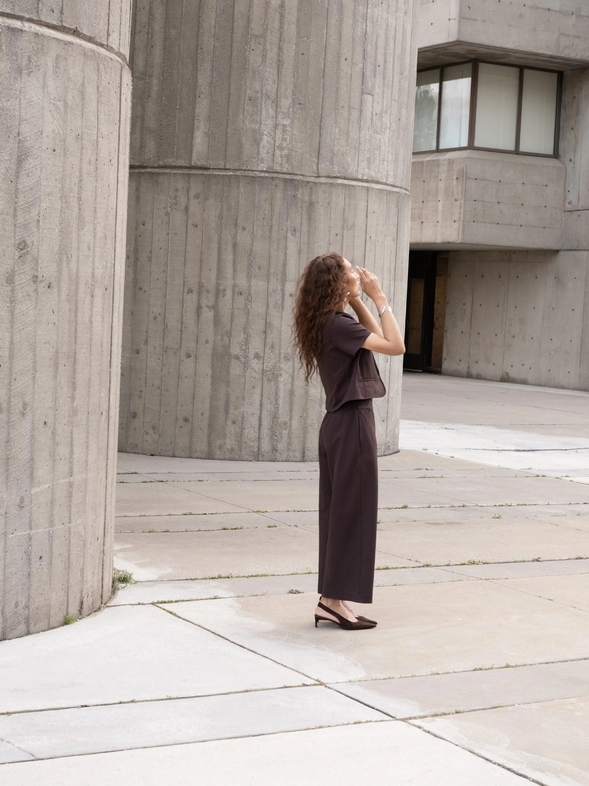 Valentina Chiarello wearing COS tailoring against Brutalist architecture in Toronto - COS campaign photographed by Chiarello Archives 