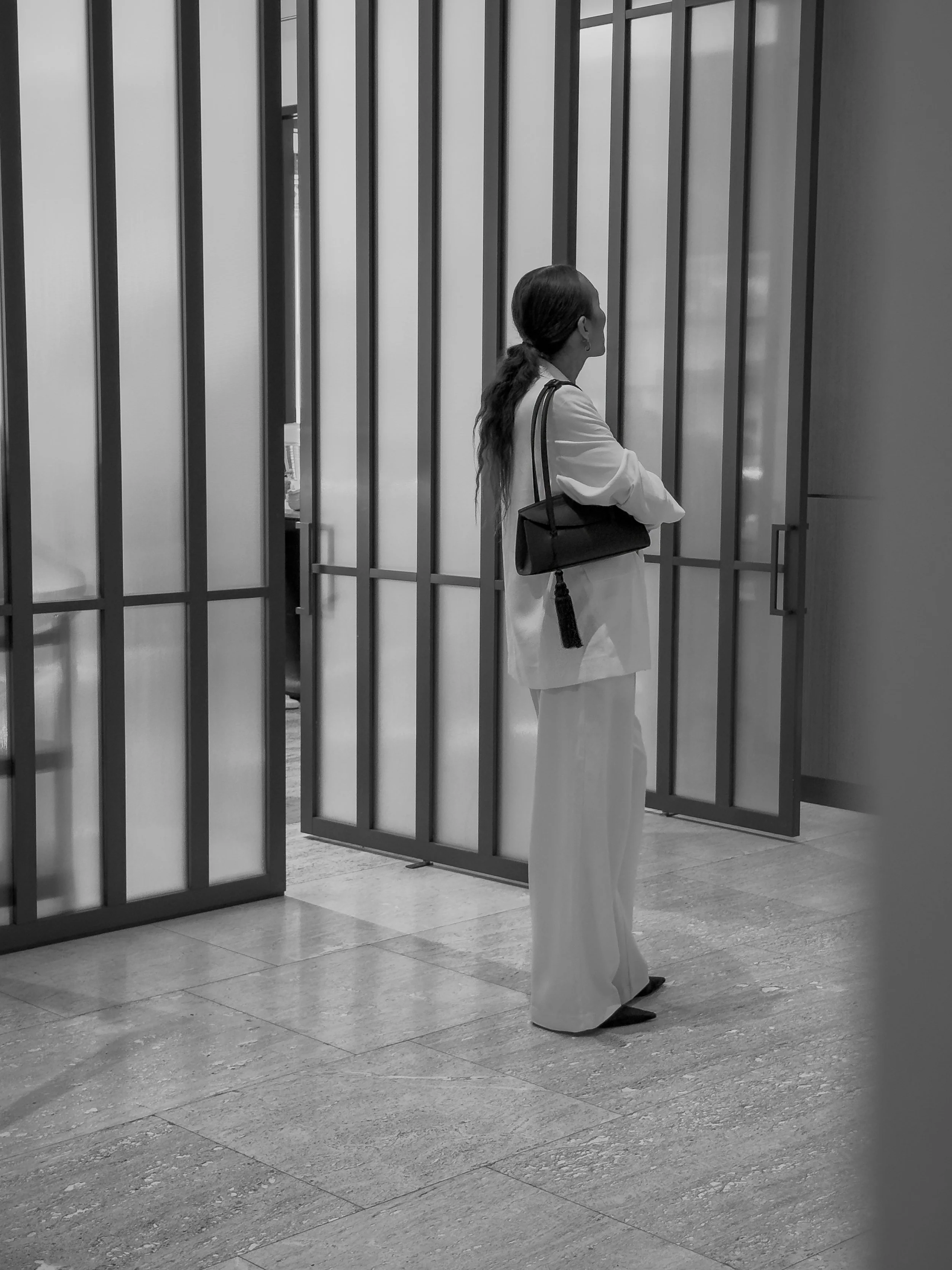 Valentina Chiarello in a white Toteme suit at Vogue Hotel Montreal, carrying a black Freja New York Caroline Bag - Photographed by Chiarello Archives 