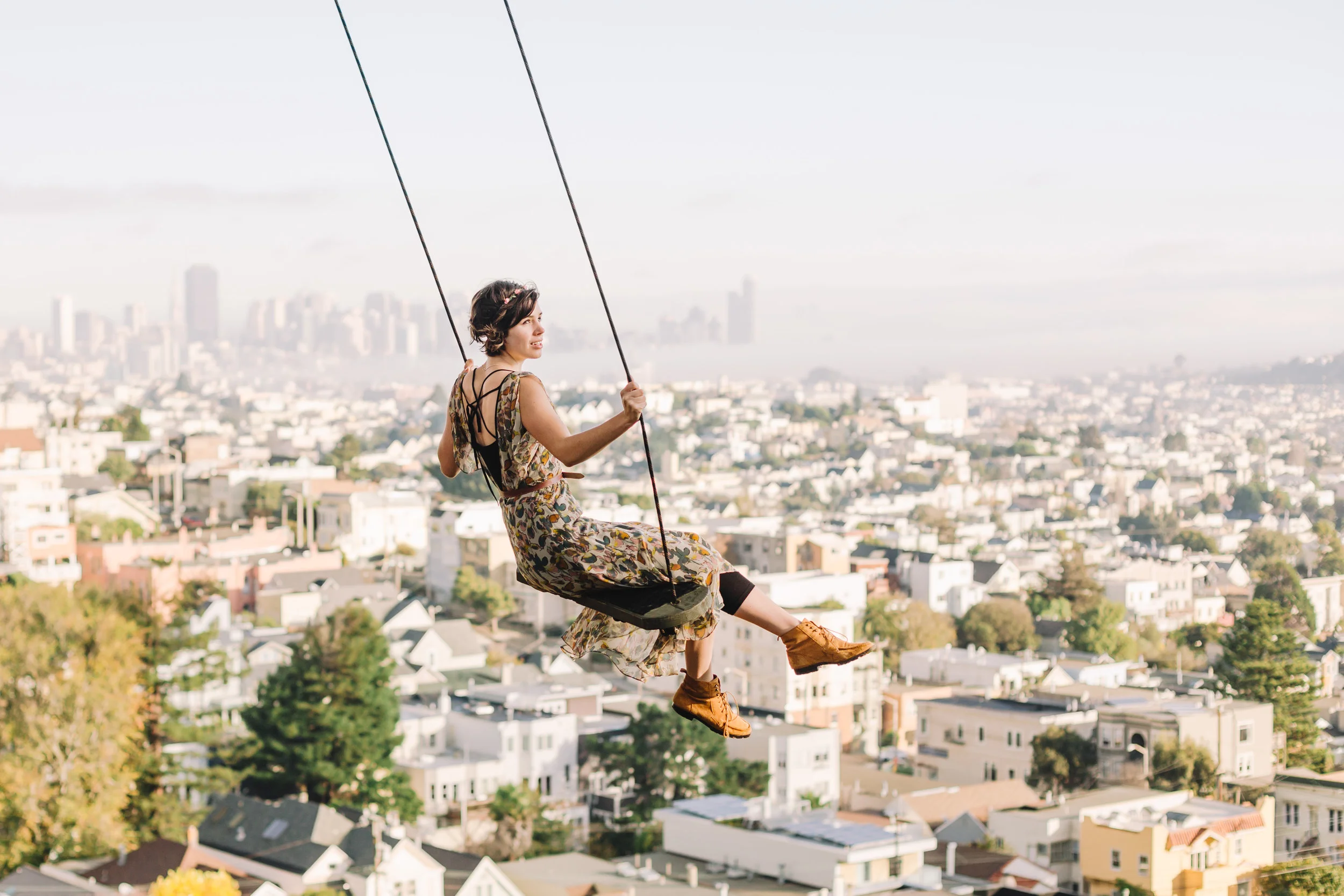 portrait of white female model on rope swing in san francisco